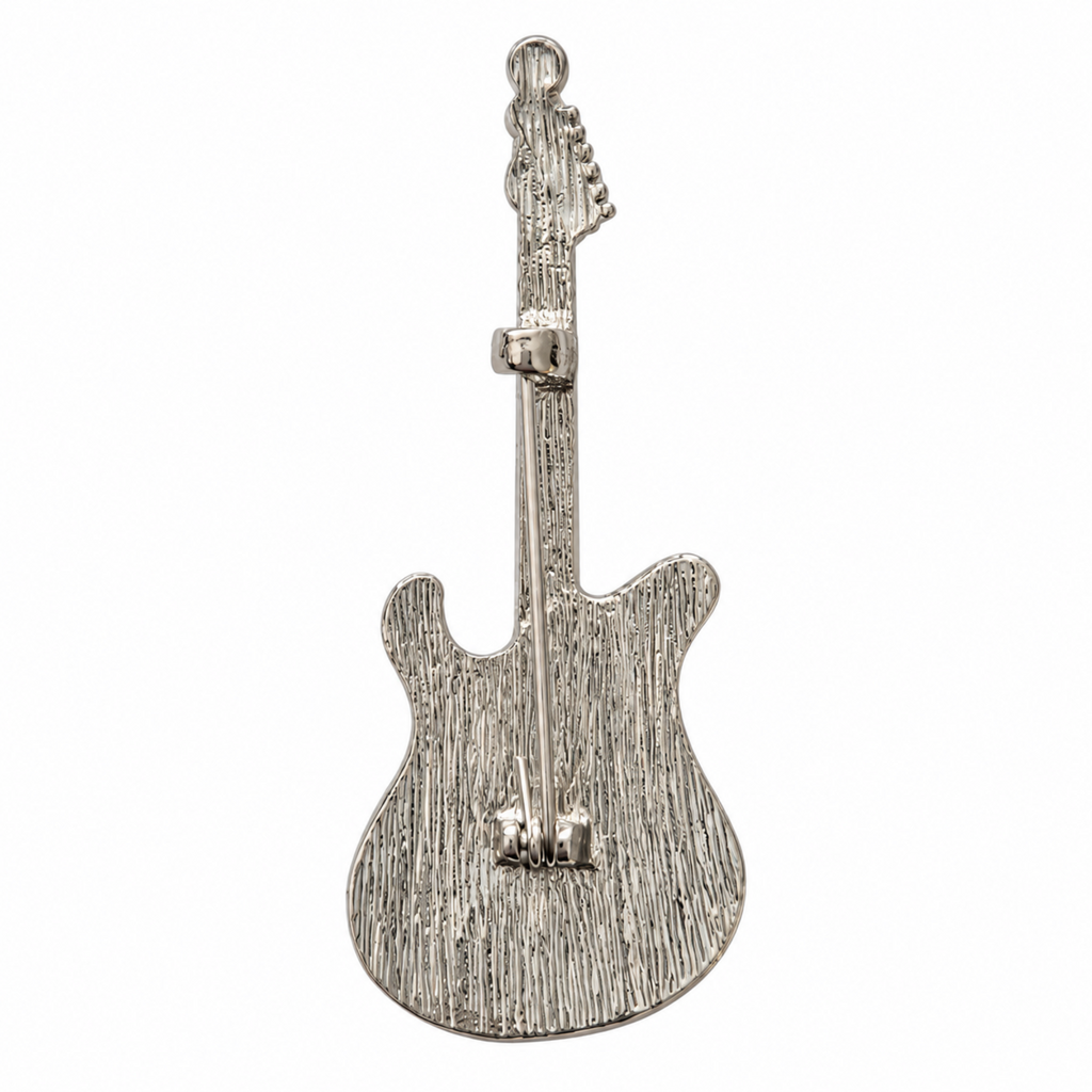 Silver-tone electric guitar brooch with a pearlescent white and black enamel body and clear rhinestones along the neck, shown on a white background.