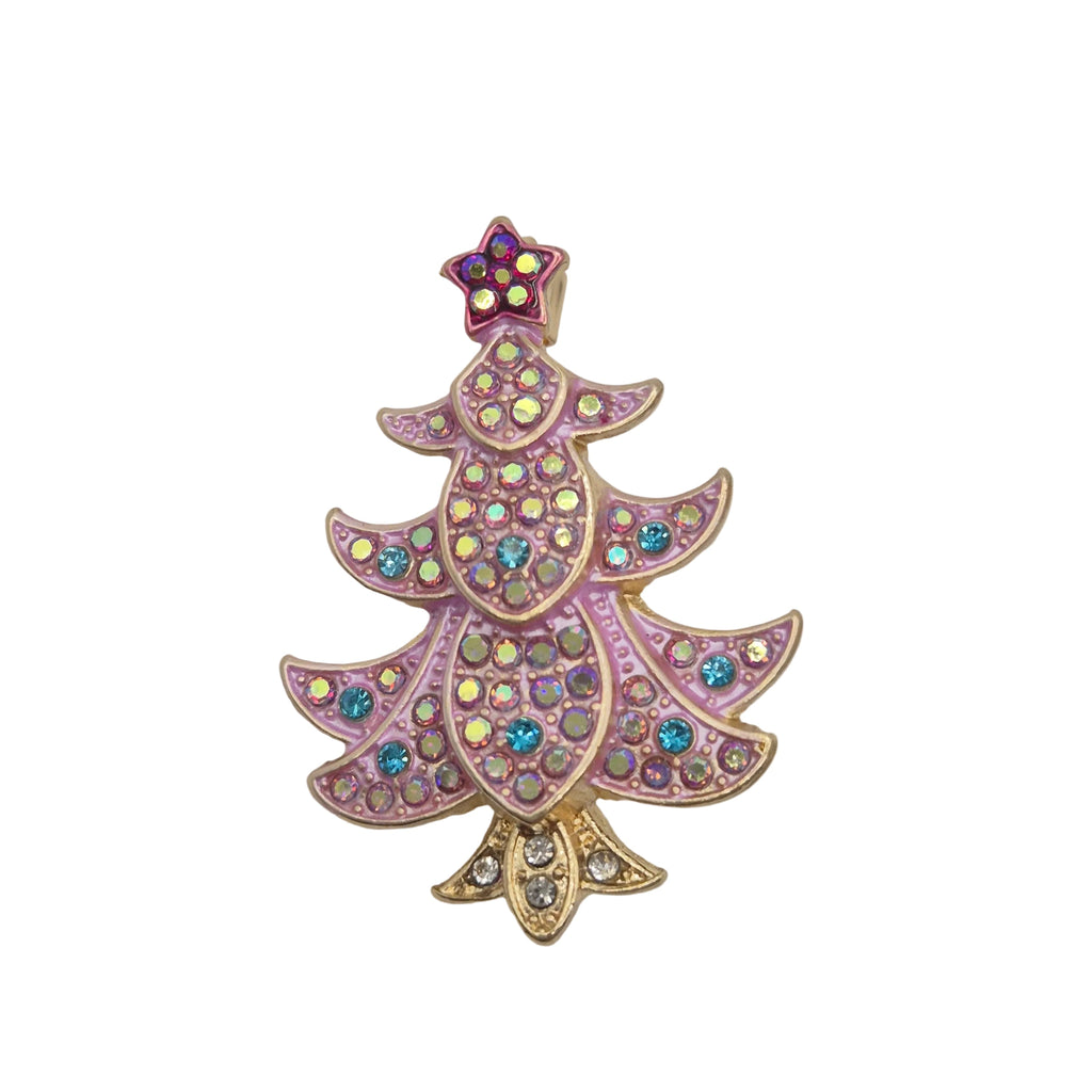 A Christmas tree-shaped brooch featuring pink and gold-tone metalwork, embellished with iridescent rhinestones and a small purple star topper, set against a plain white background.