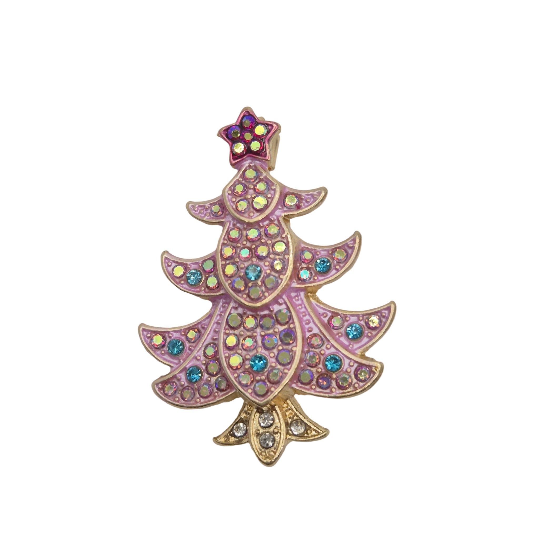 A Christmas tree-shaped brooch featuring pink and gold-tone metalwork, embellished with iridescent rhinestones and a small purple star topper, set against a plain white background.