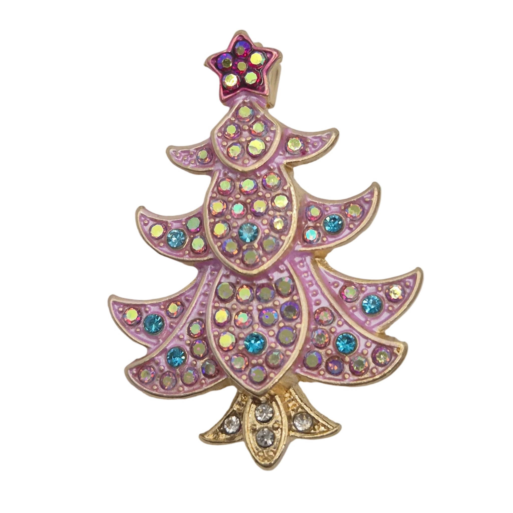 A Christmas tree-shaped brooch with pink enamel, gold-tone metal outlines, and iridescent rhinestones in shades of blue, green, and purple, set against a plain white background.