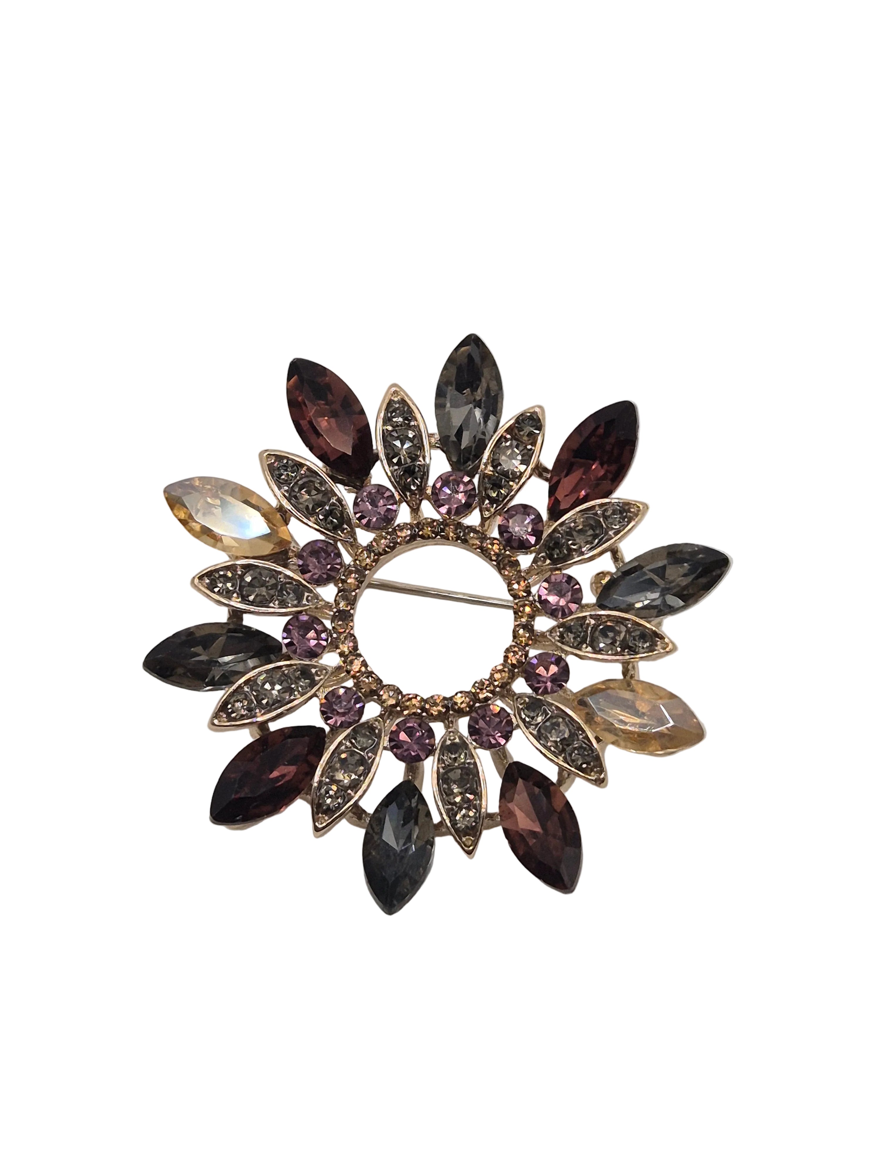 jewelled wreath brooch with multicolored gemstones on a white background