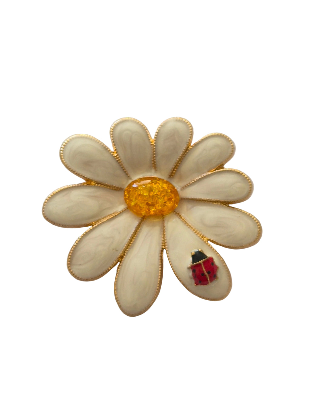 White flower-shaped brooch with a red ladybird on a white background