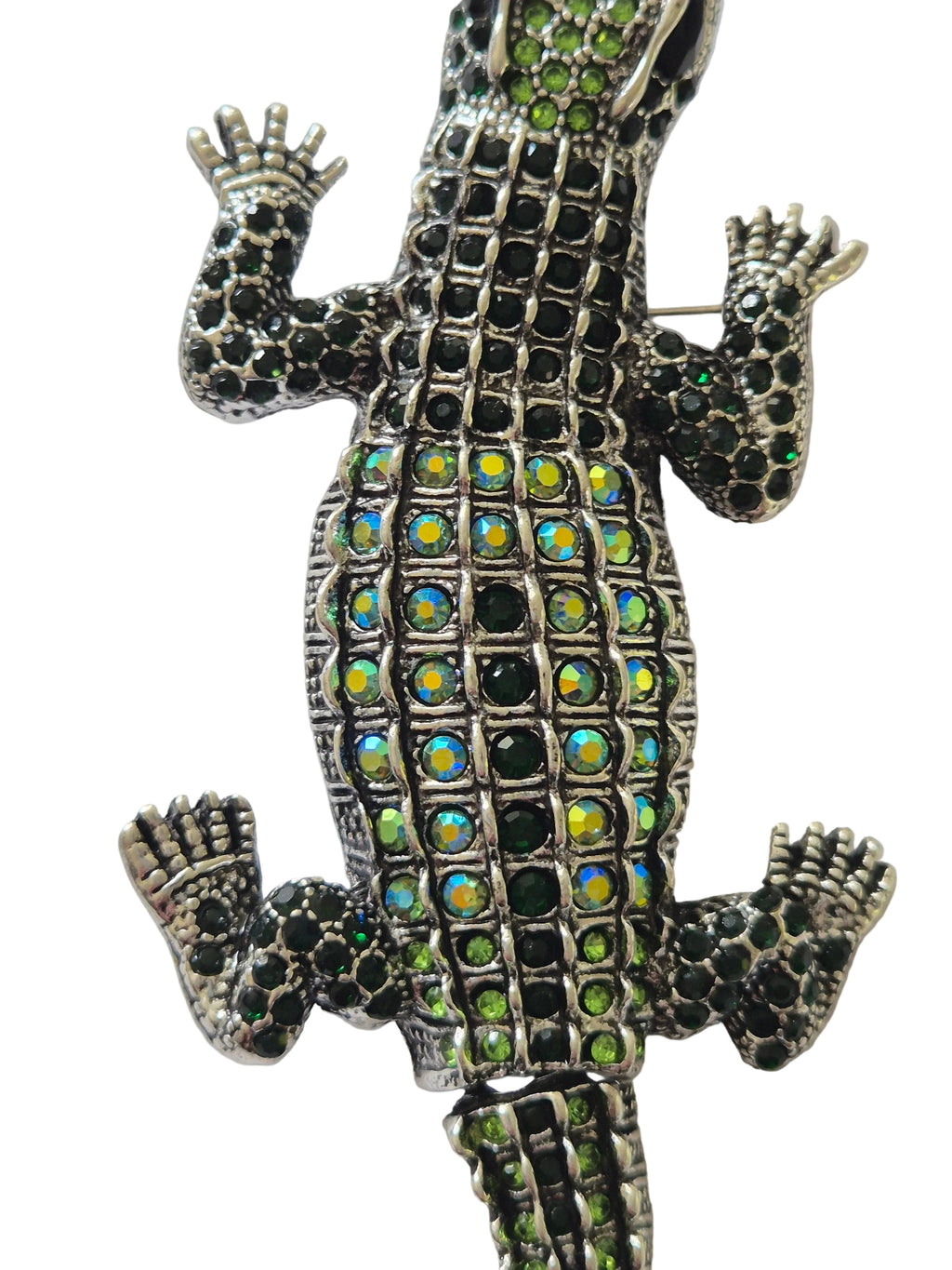 Decorative crocodile brooch with gemstones on a white background