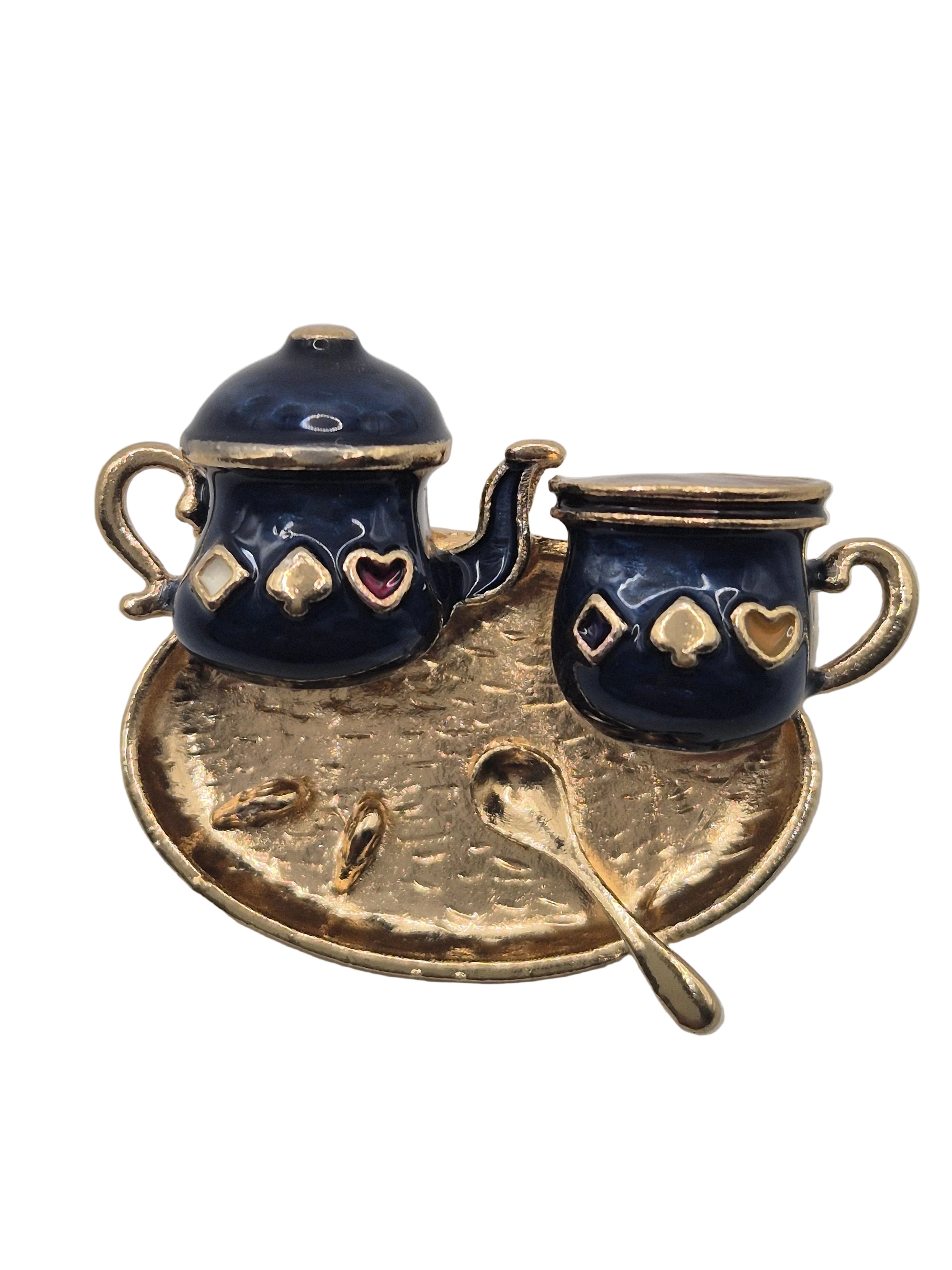 A traditional Turkish style coffee pot and cup with gold-tone accents, displayed on a matching hammered gold tray with a small spoon, isolated on a white background.