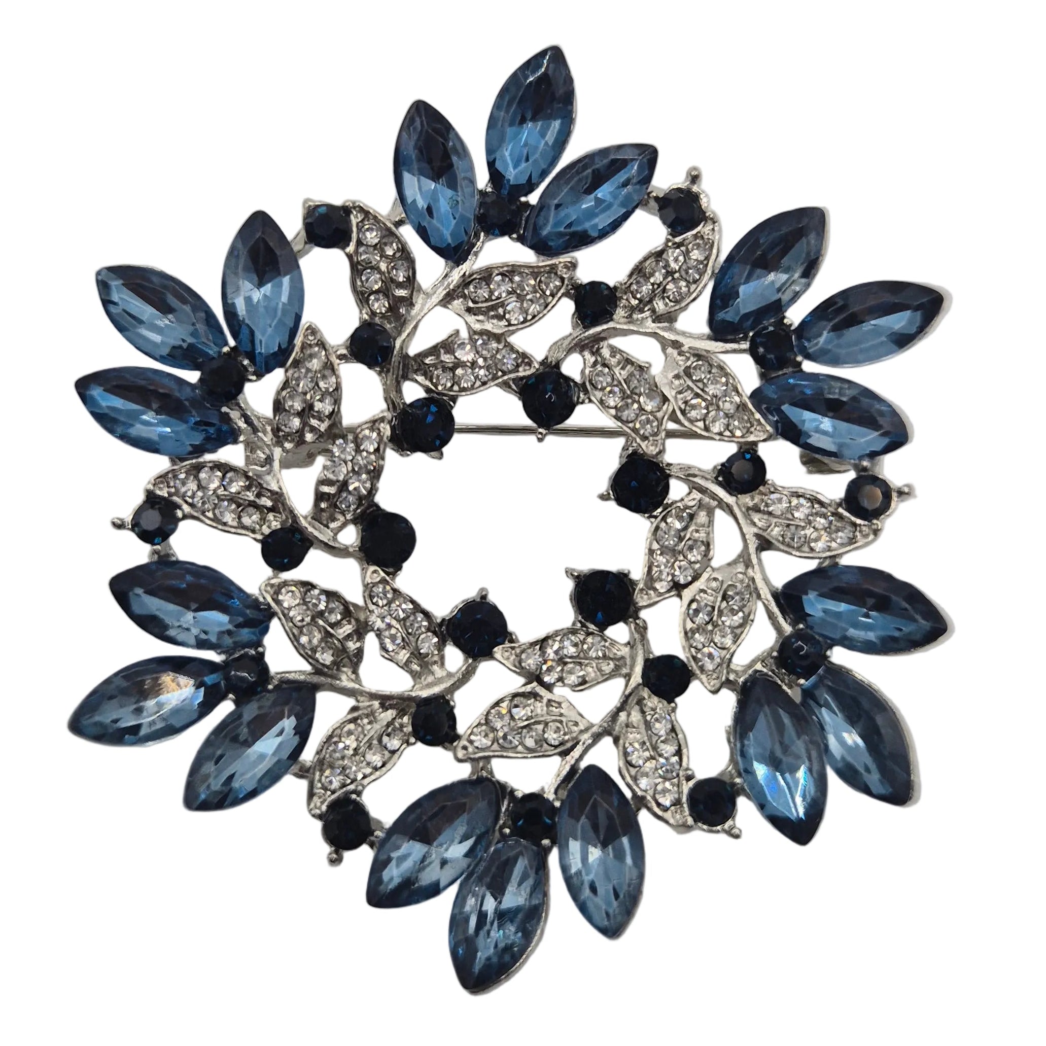 Blue and silver wreath brooch on white background close up