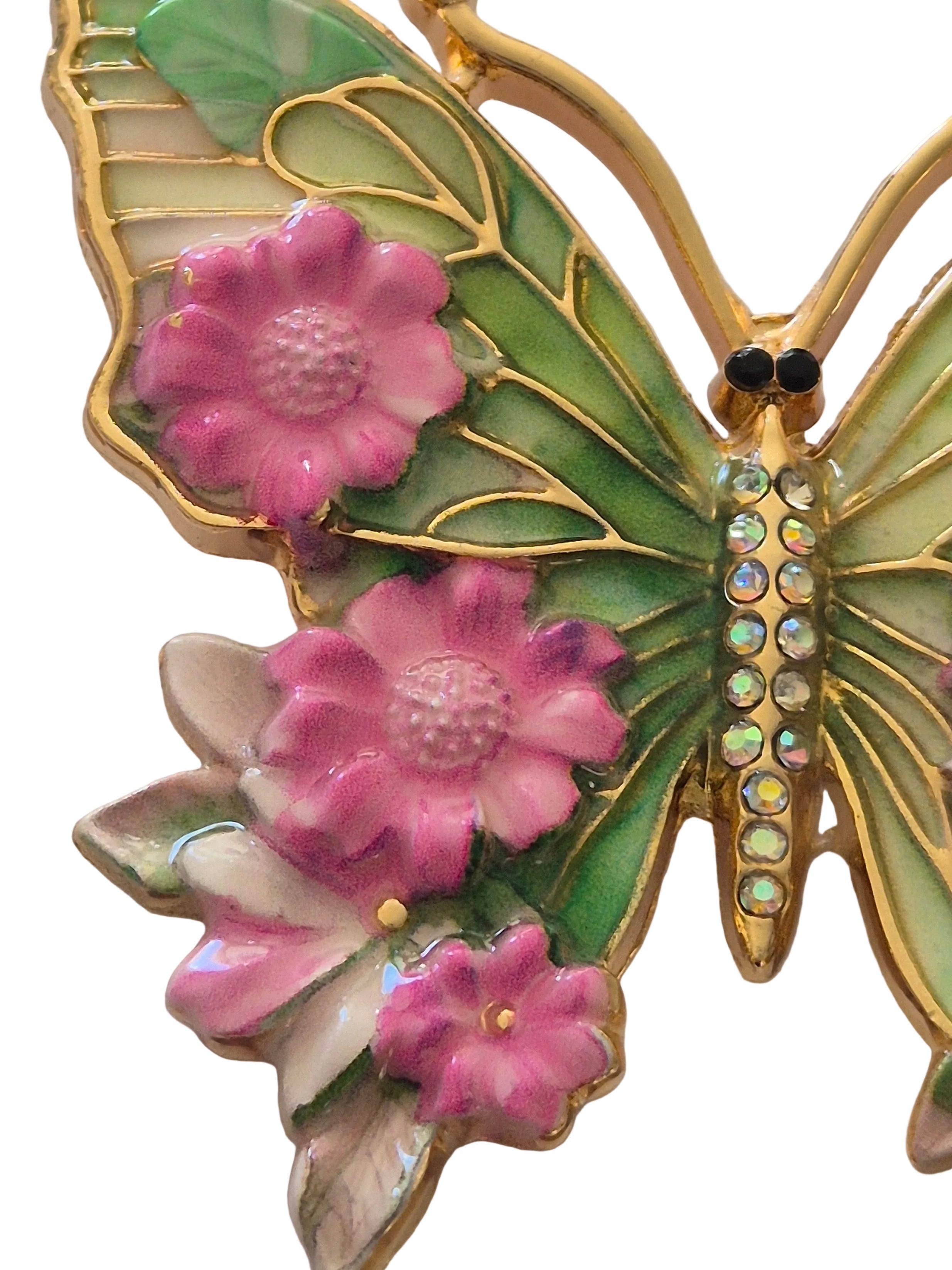 Butterfly brooch with pink flowers on a white background