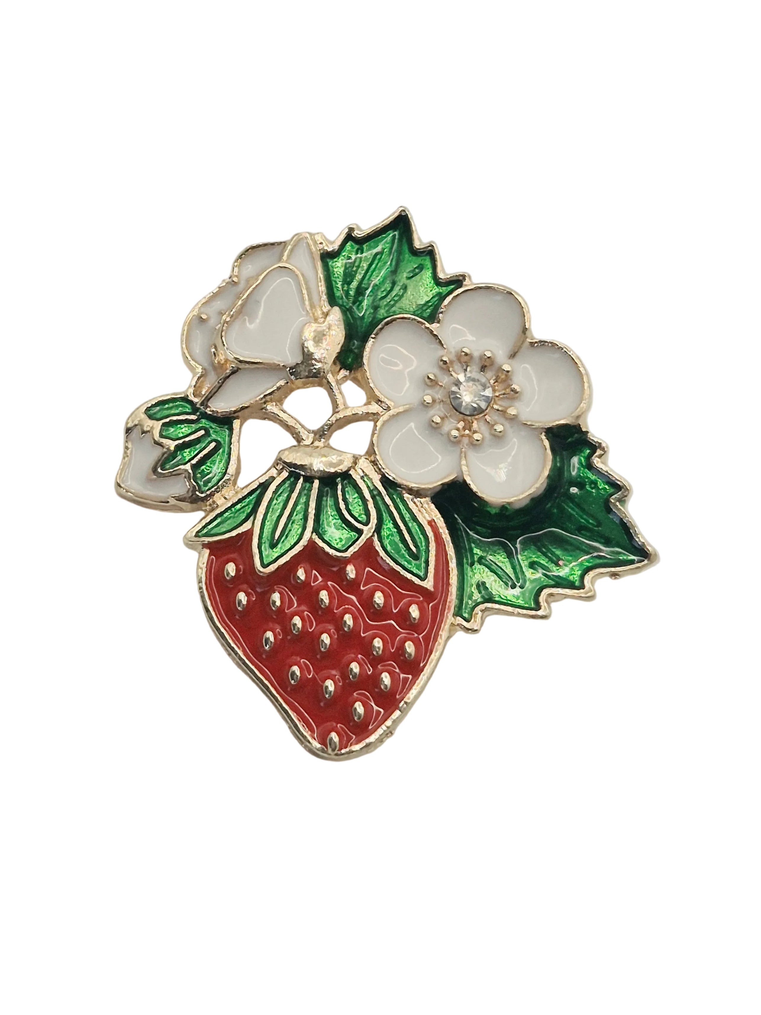 A red and white strawberry fruit and flowers brooch on a plain white background. 
