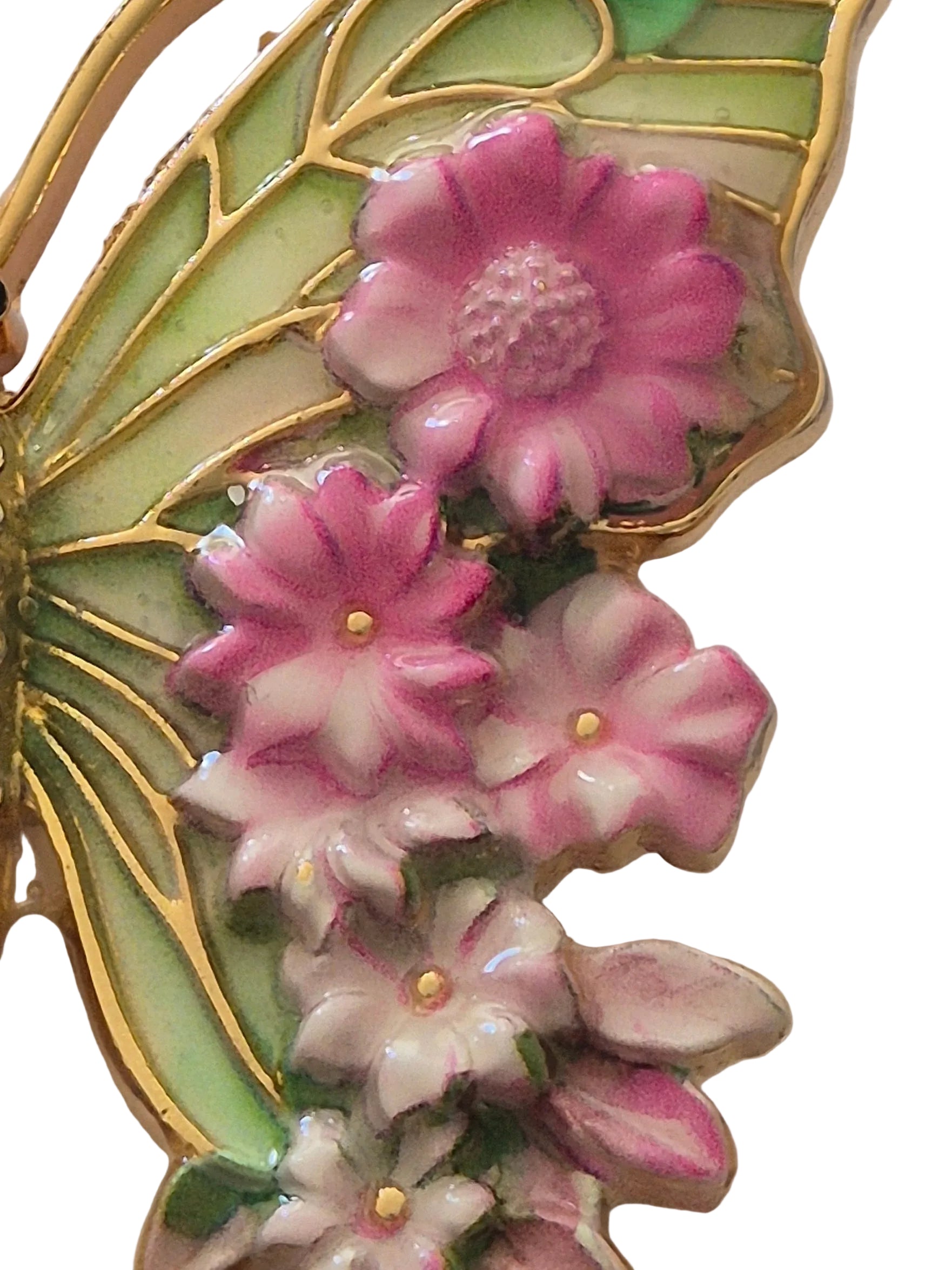 Butterfly-shaped brooch with pink flowers on a white background