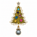 A gold Christmas tree pendant brooch featuring a green and white patterned body, colorful gemstone ornaments, a star on top, and a dangling gray pearl at the bottom.