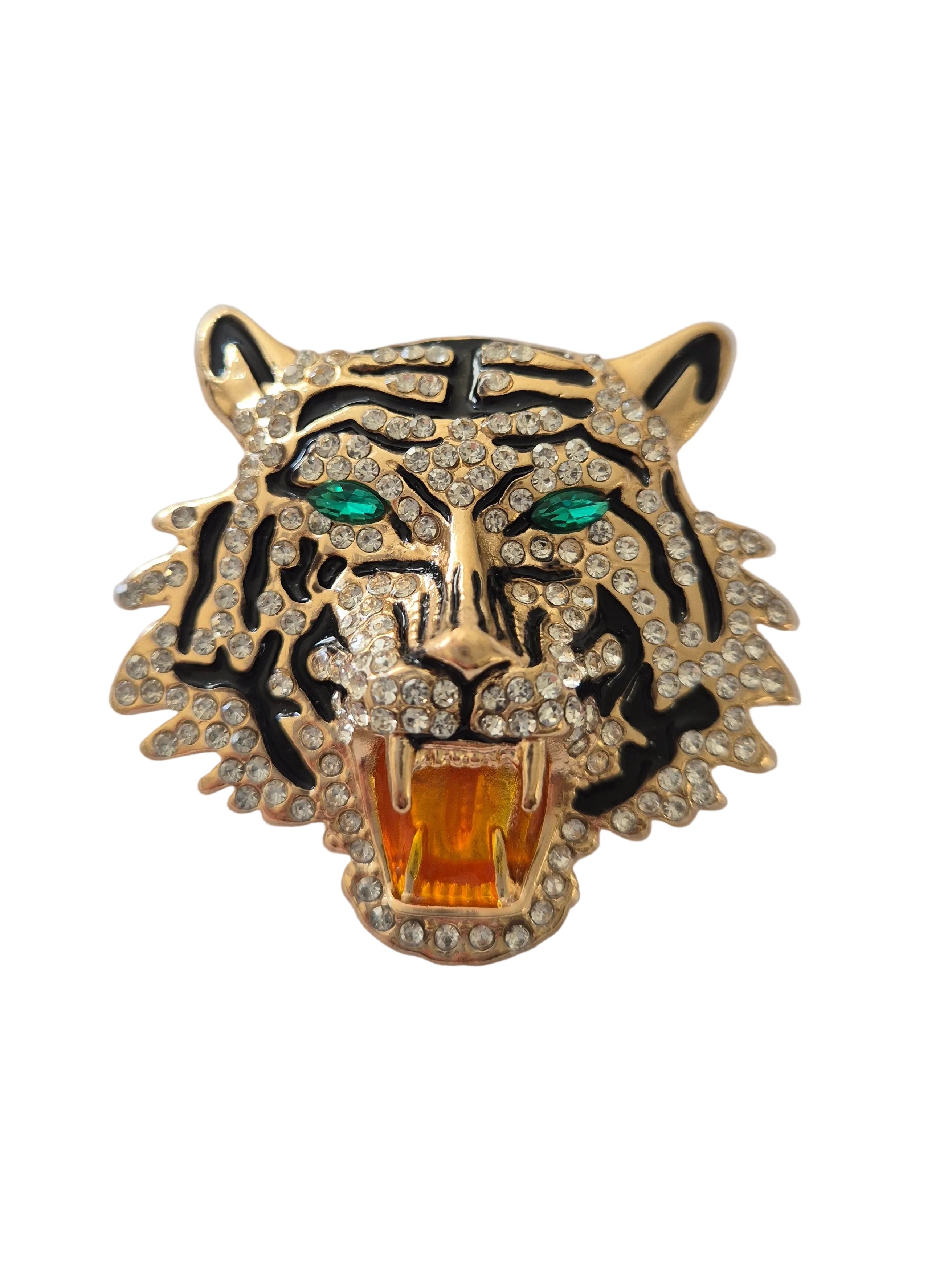 Gold tiger head brooch  with green eyes and orange mouth on a white background