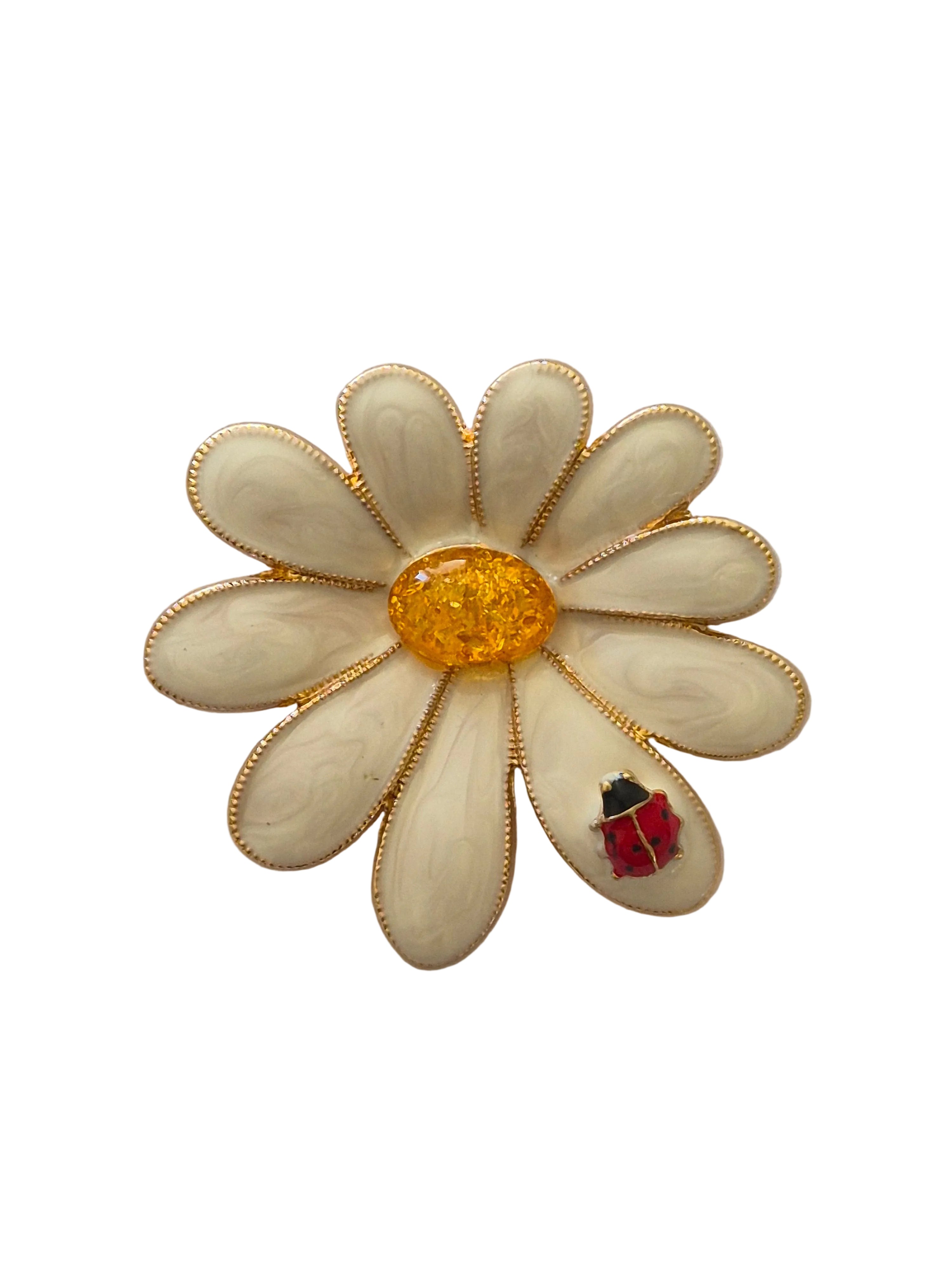 White flower-shaped brooch with a red and black ladybug on a white background