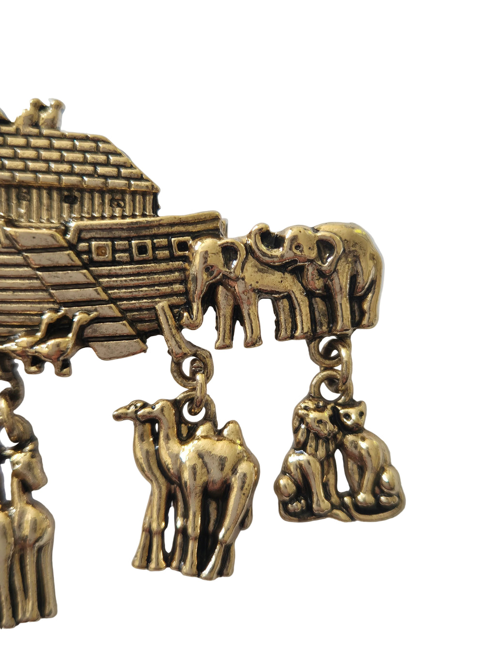 gold charm brooch with Noah's Ark, animals, and a woman on a white background