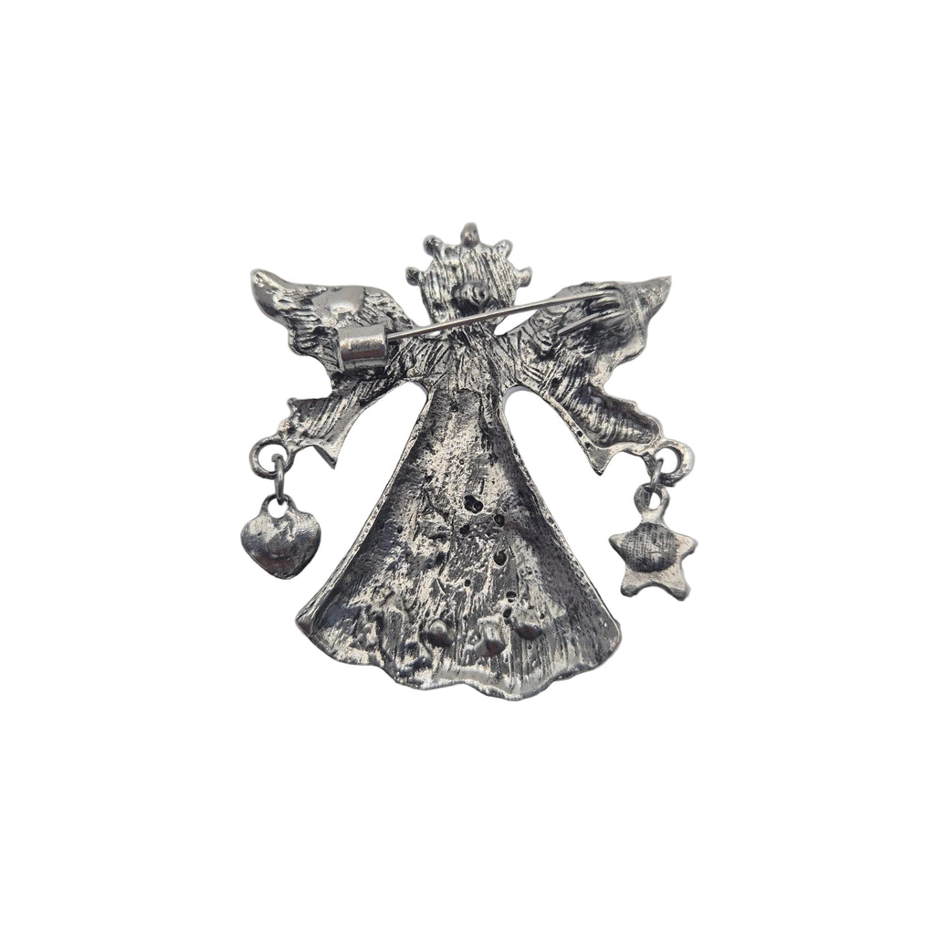 A silver-toned metal angel brooch with outstretched wings, a crown, and dangling heart and star charms, shown on a plain white background.