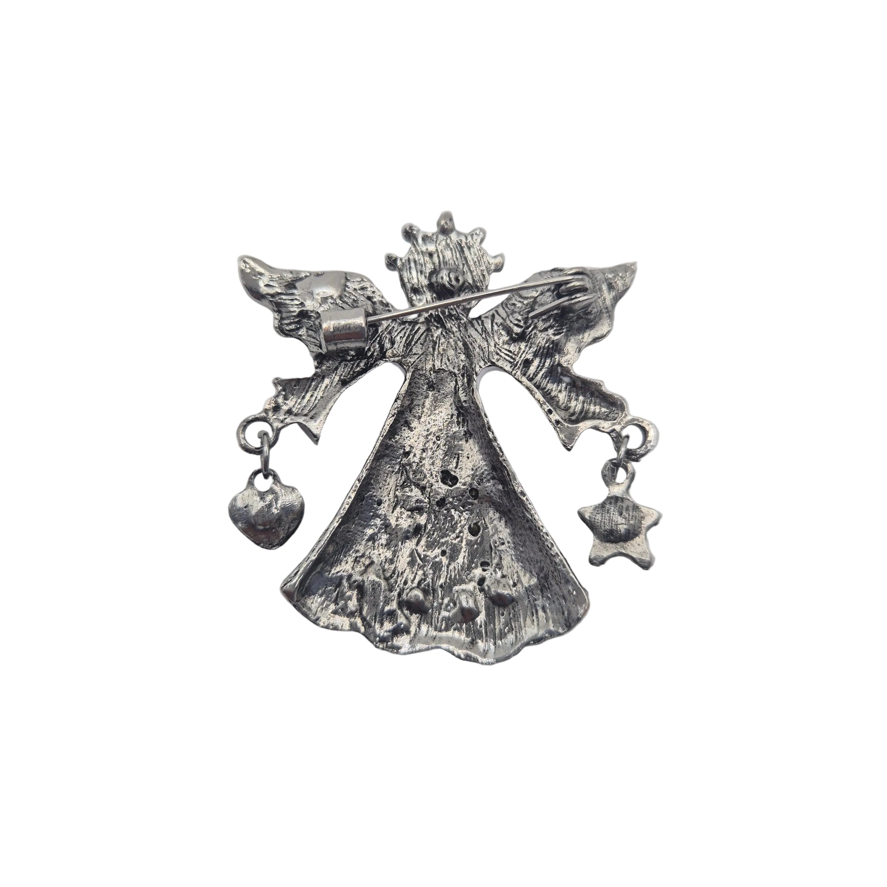 A silver-toned metal angel brooch with outstretched wings, a crown, and dangling heart and star charms, shown on a plain white background.