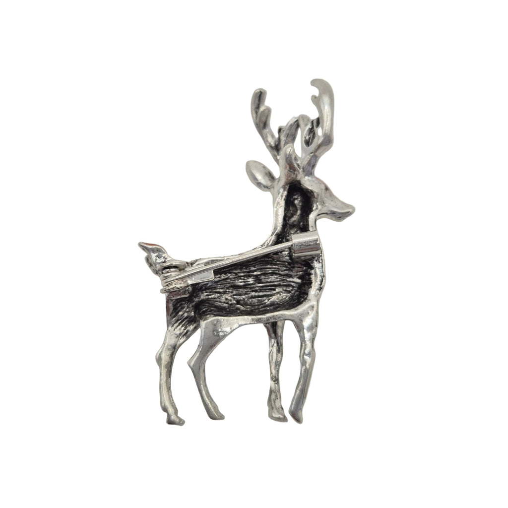 A small silver deer charm or pendant with textured detailing, shown on a plain light gray background.