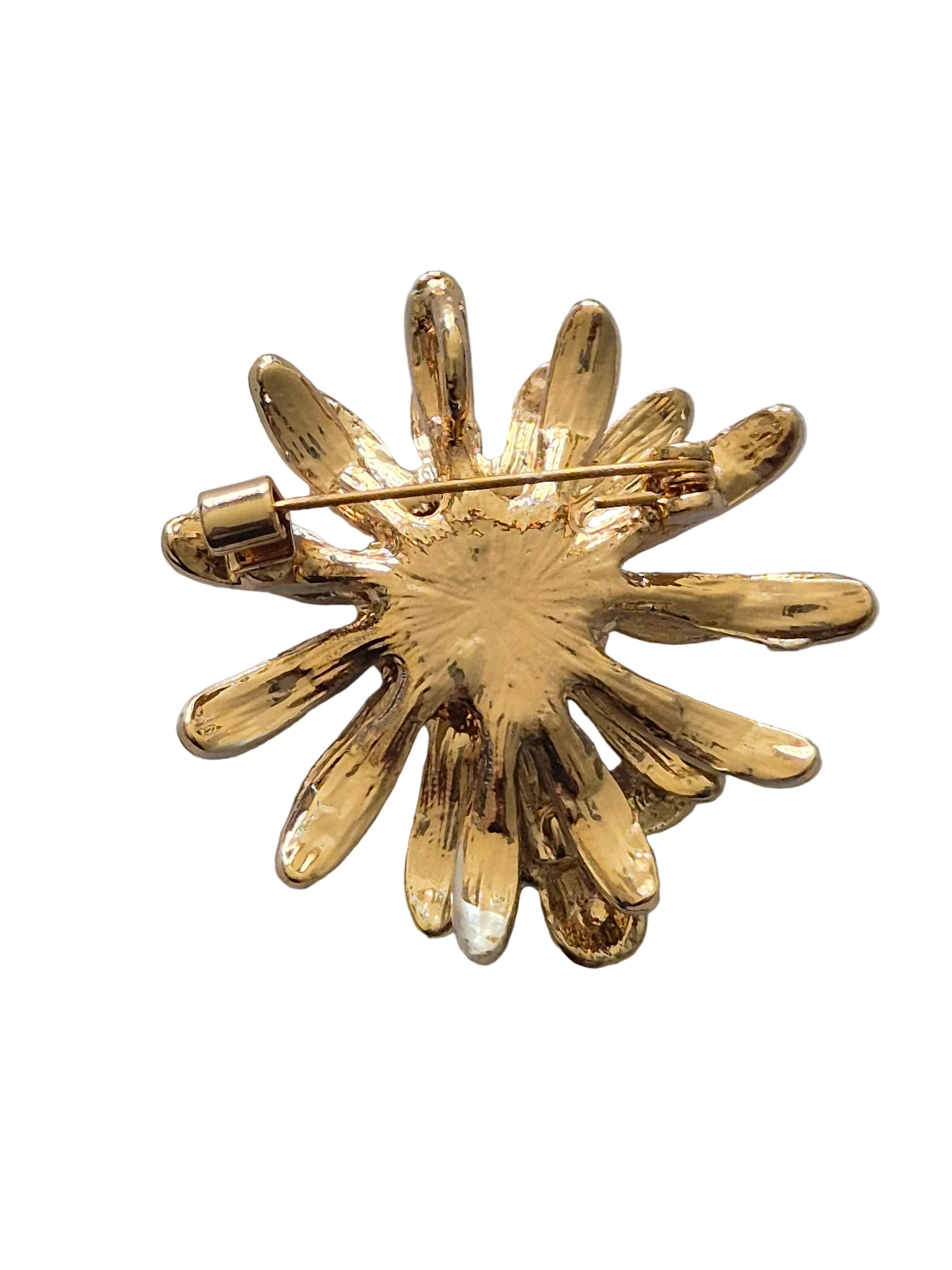 Gold daisy bee brooch on a white background