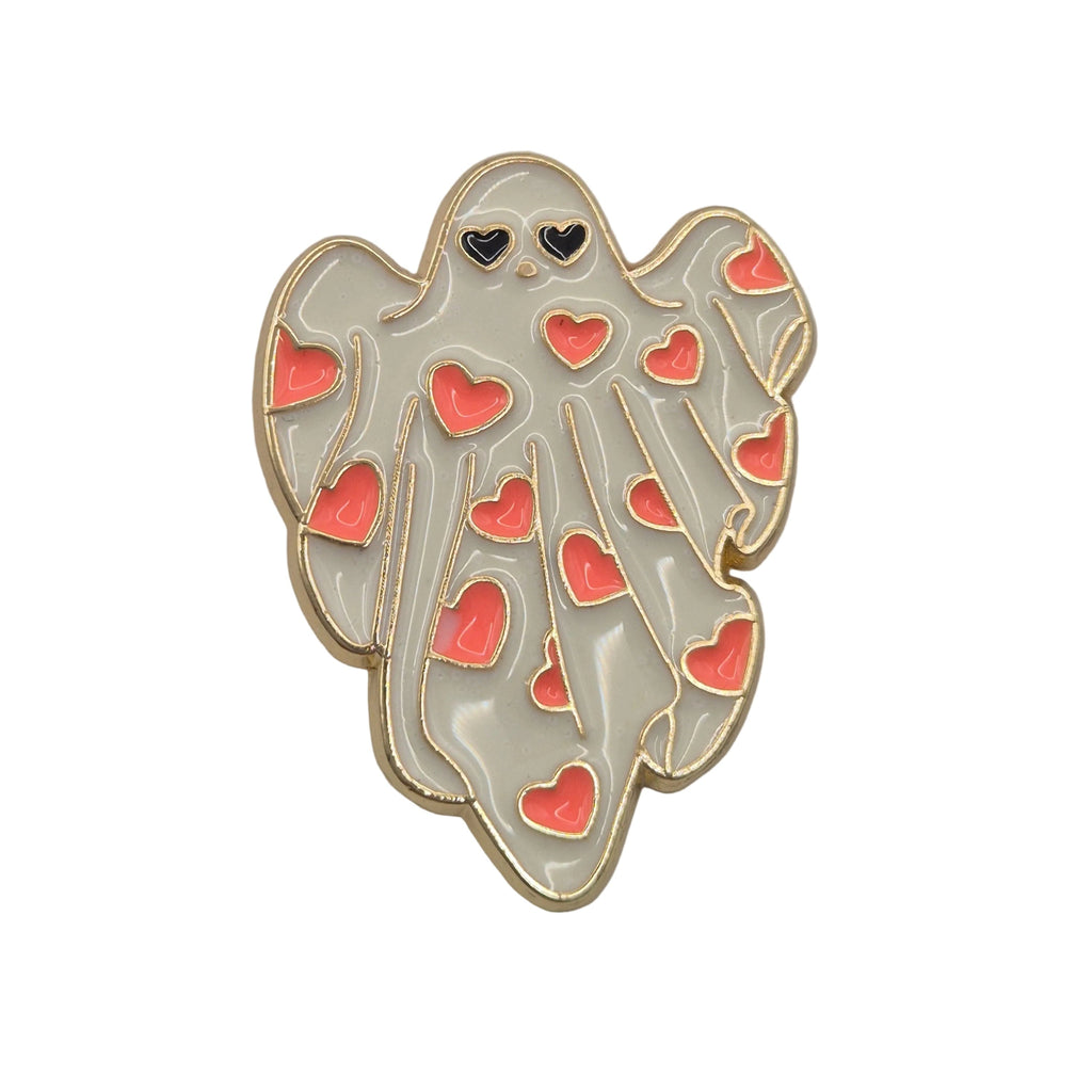 A cute ghost-shaped enamel pin with a gold outline, white body, and pink hearts, photographed on a plain white background.