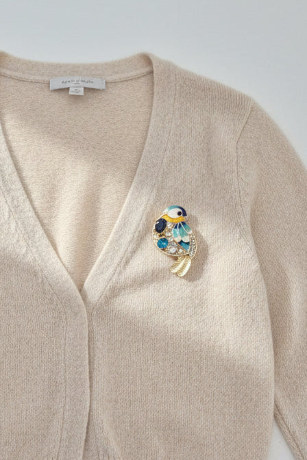 Blue and Gold Bird Brooch with Rhinestone Detail on cardigan