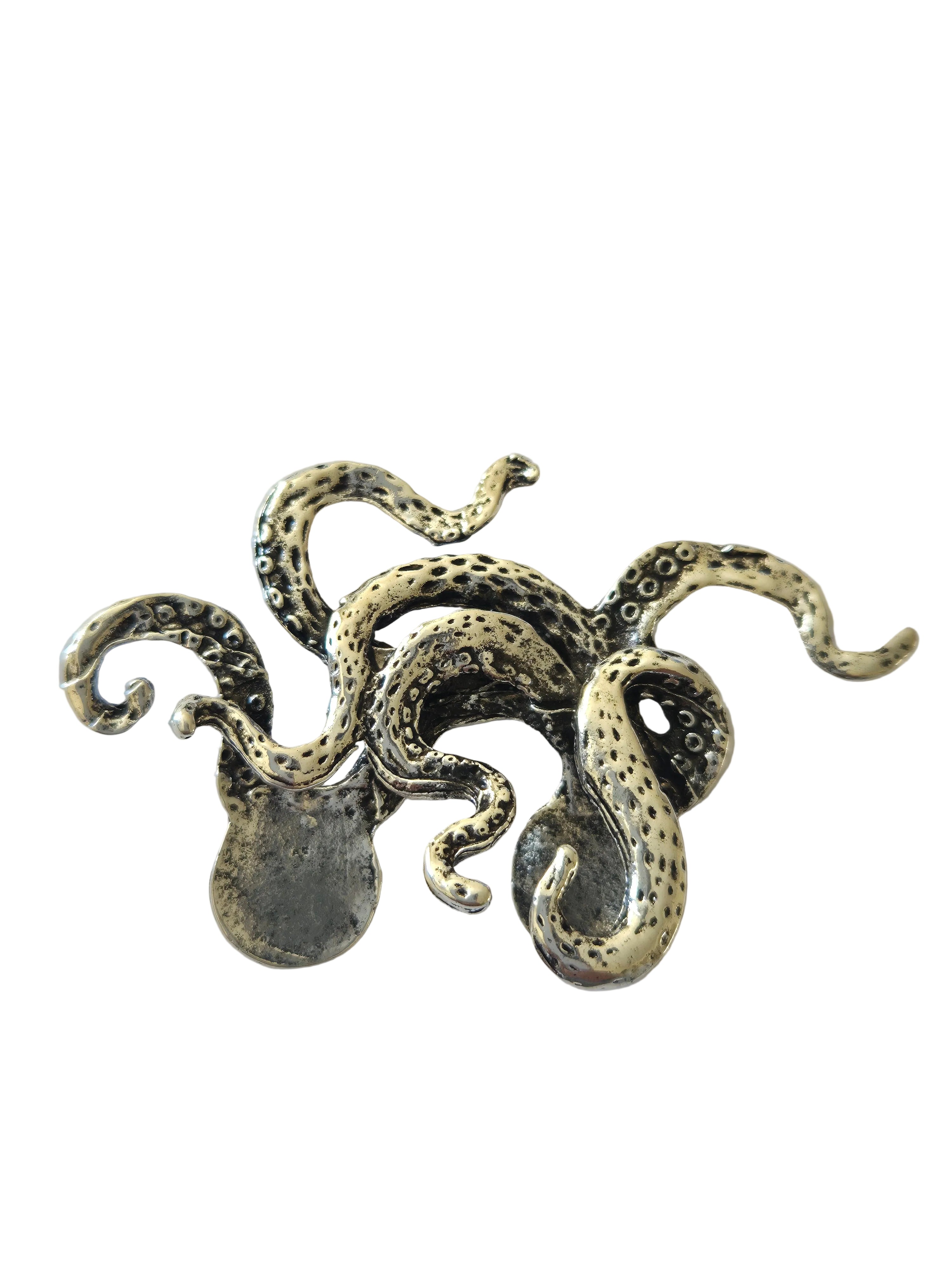 Silver octopus brooch
 on a light gray background