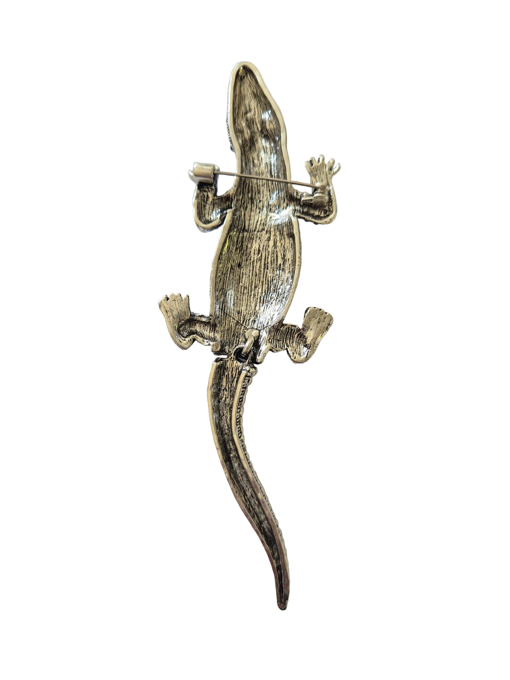 crocodile shaped brooch on a light gray background
