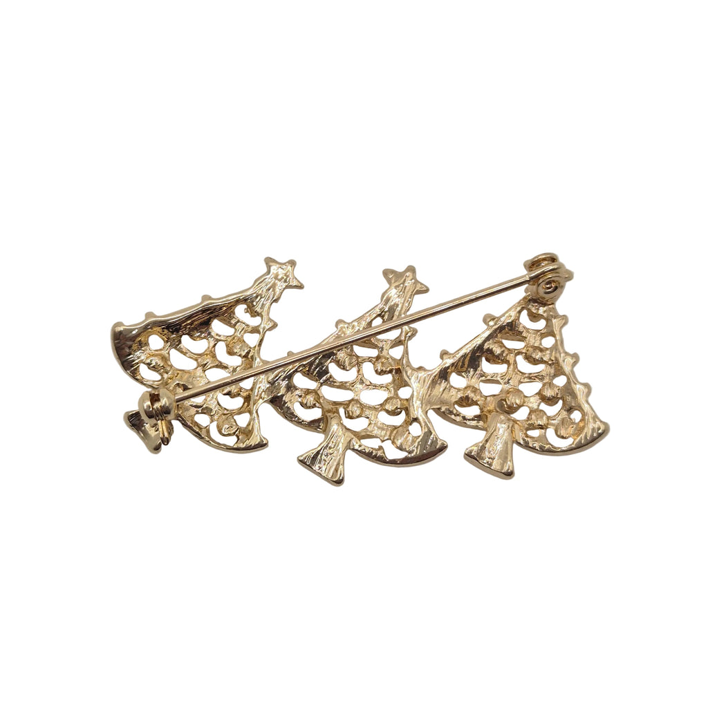 A gold-tone pin featuring three stylized, openwork tree-like shapes connected by a horizontal bar, photographed on a plain white background.