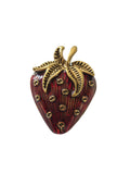 Vintage inspired strawberry brooch with gold and red detail on a white background"