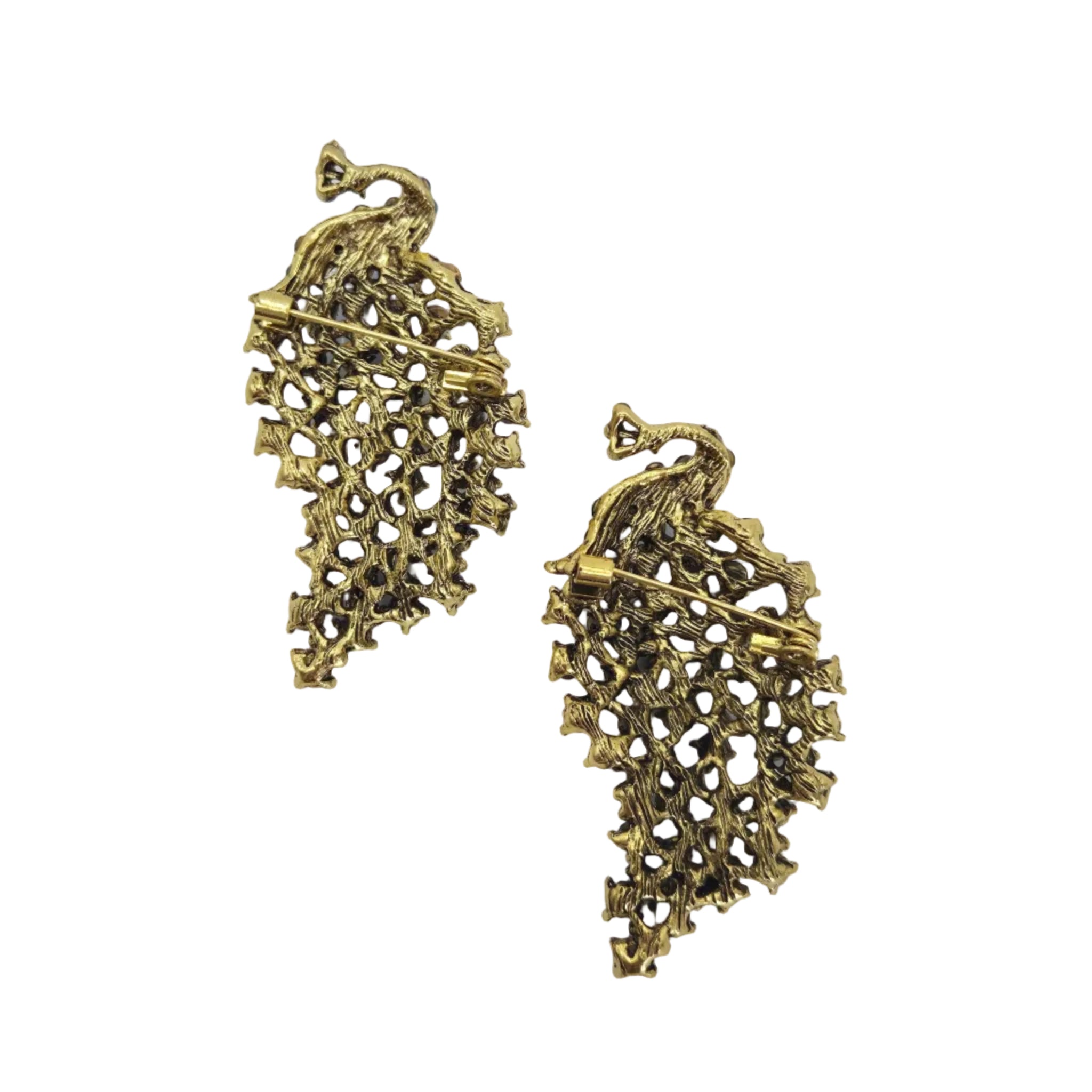 A pair of vintage gold-tone peacock shaped brooches with openwork detailing and a pin-back clasp, displayed on a white background.