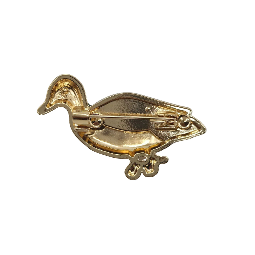 A gold-colored duck-shaped brooch with a visible pin mechanism on the underside, photographed on a plain white background.