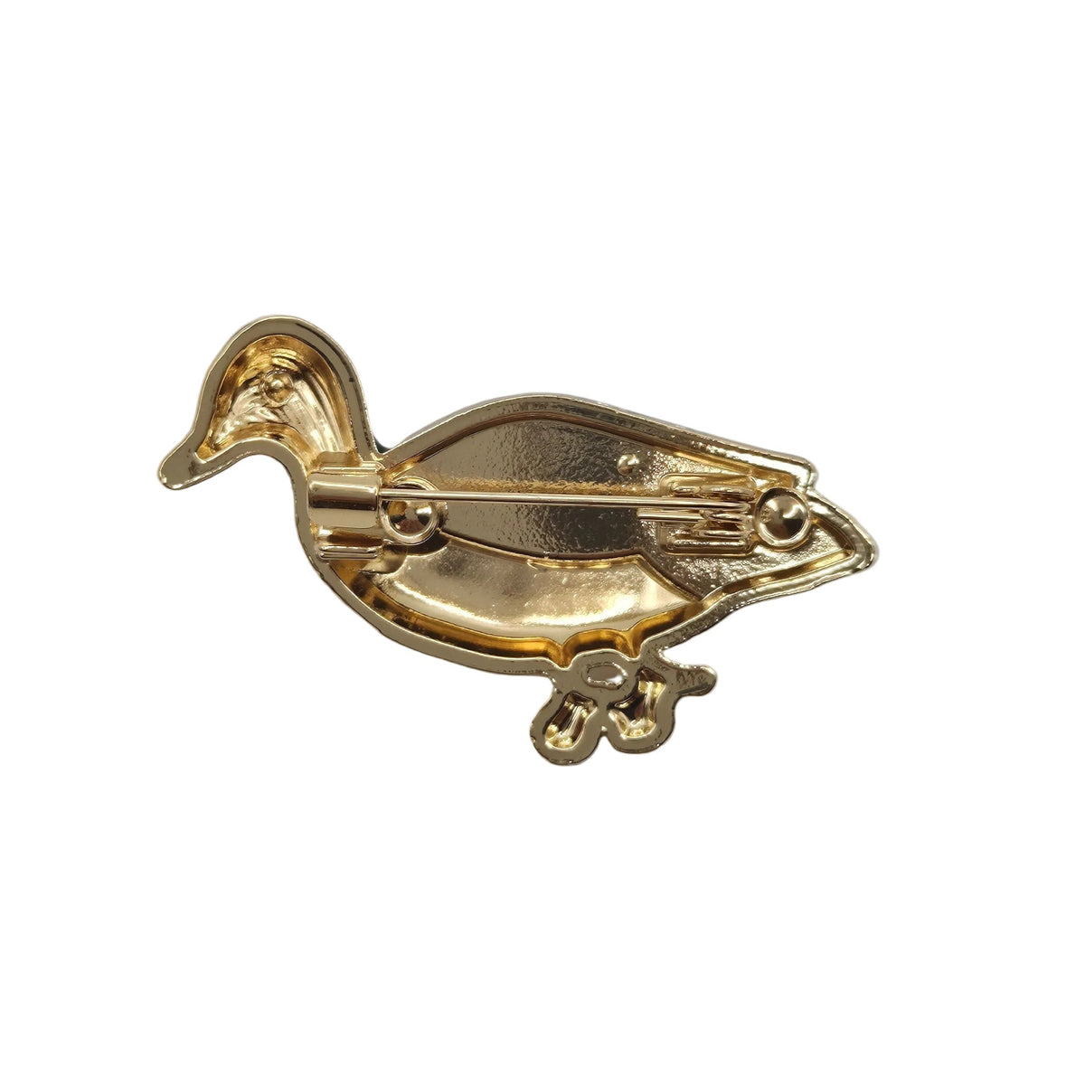 A gold-colored duck-shaped brooch with a visible pin mechanism on the underside, photographed on a plain white background.