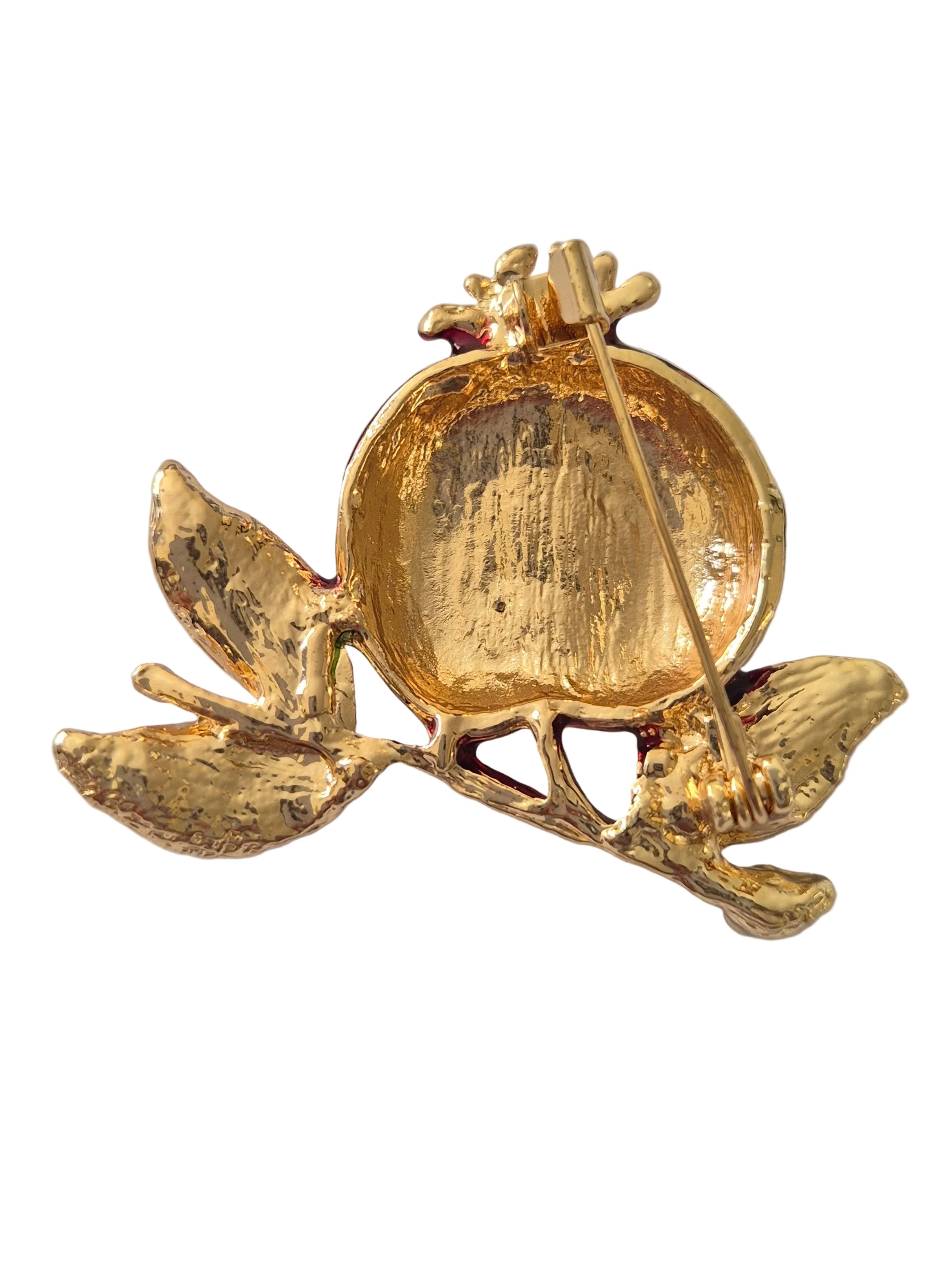 pomegranate brooch with a gray background