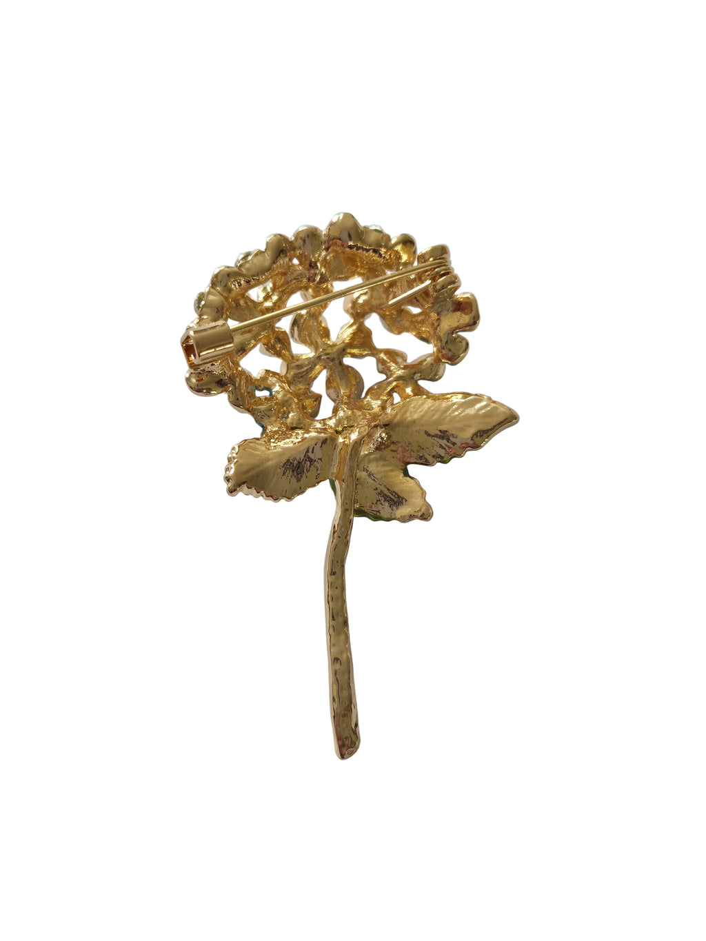Gold brooch with intricate design on a light gray background