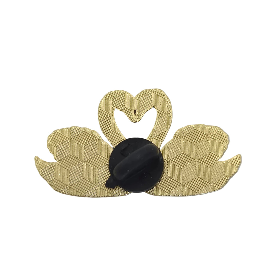 A swan-shaped brooch with a textured gold patterned body and a black oval center, shown against a plain white background.