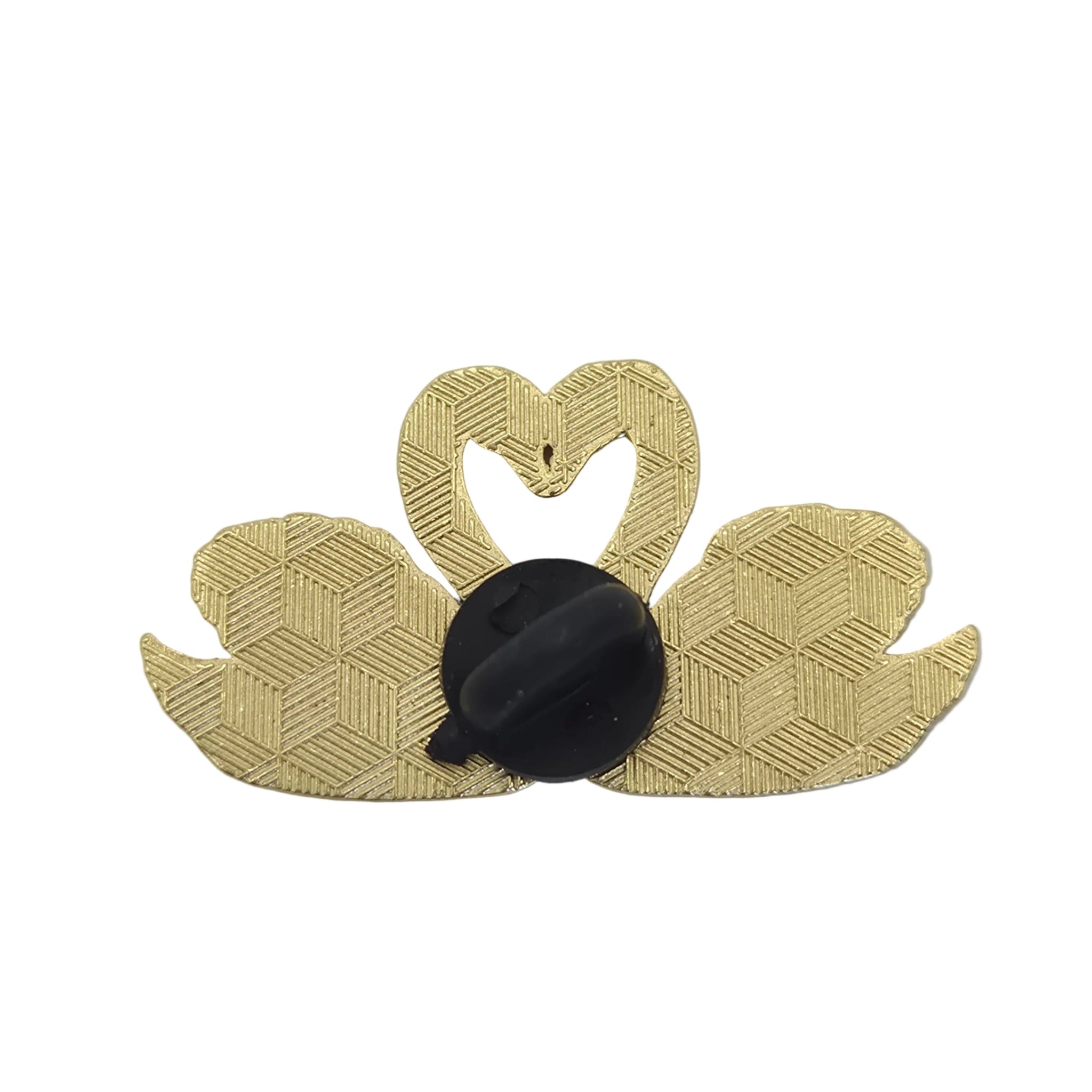 A swan-shaped brooch with a textured gold patterned body and a black oval center, shown against a plain white background.