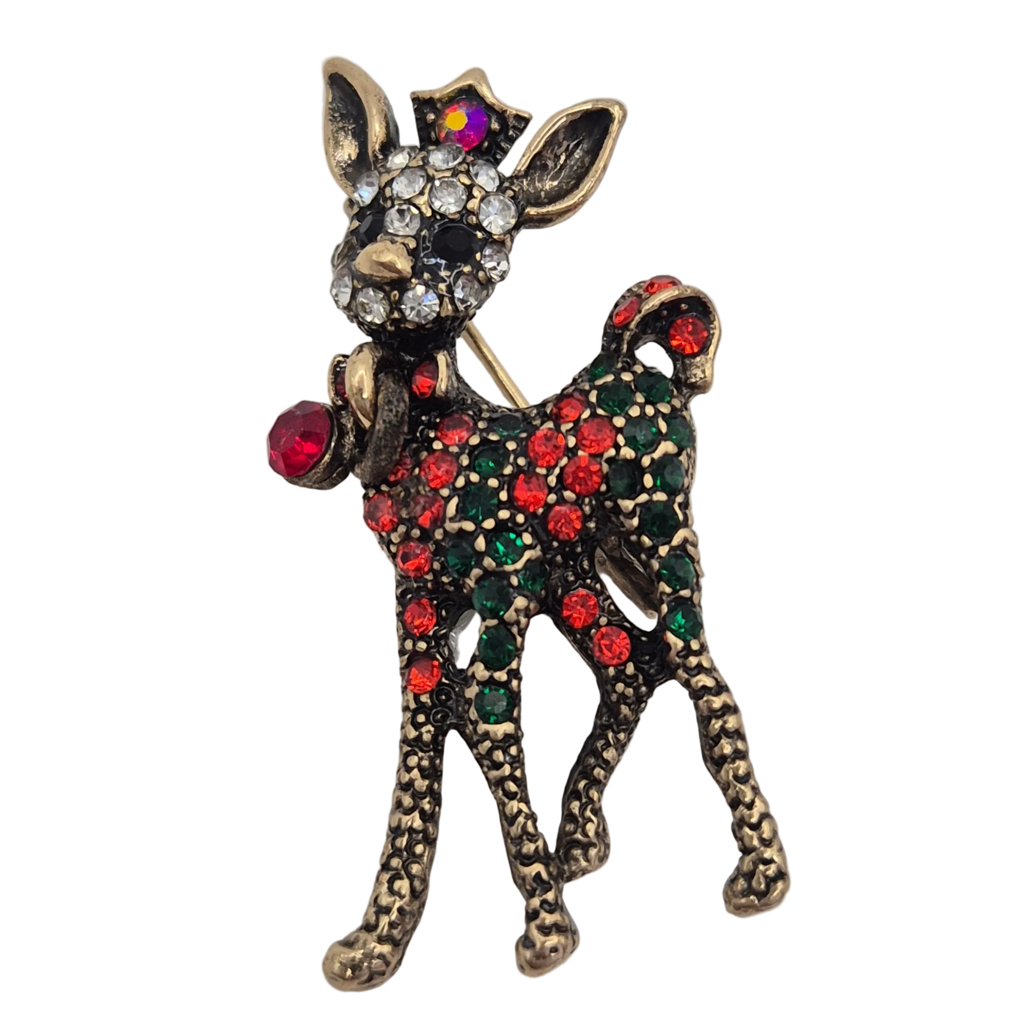 A Christmas-themed deer brooch featuring an antique gold-tone finish, adorned with red and green rhinestones on its body, a red bell, and a multicolor star on its head, set against a plain white background.