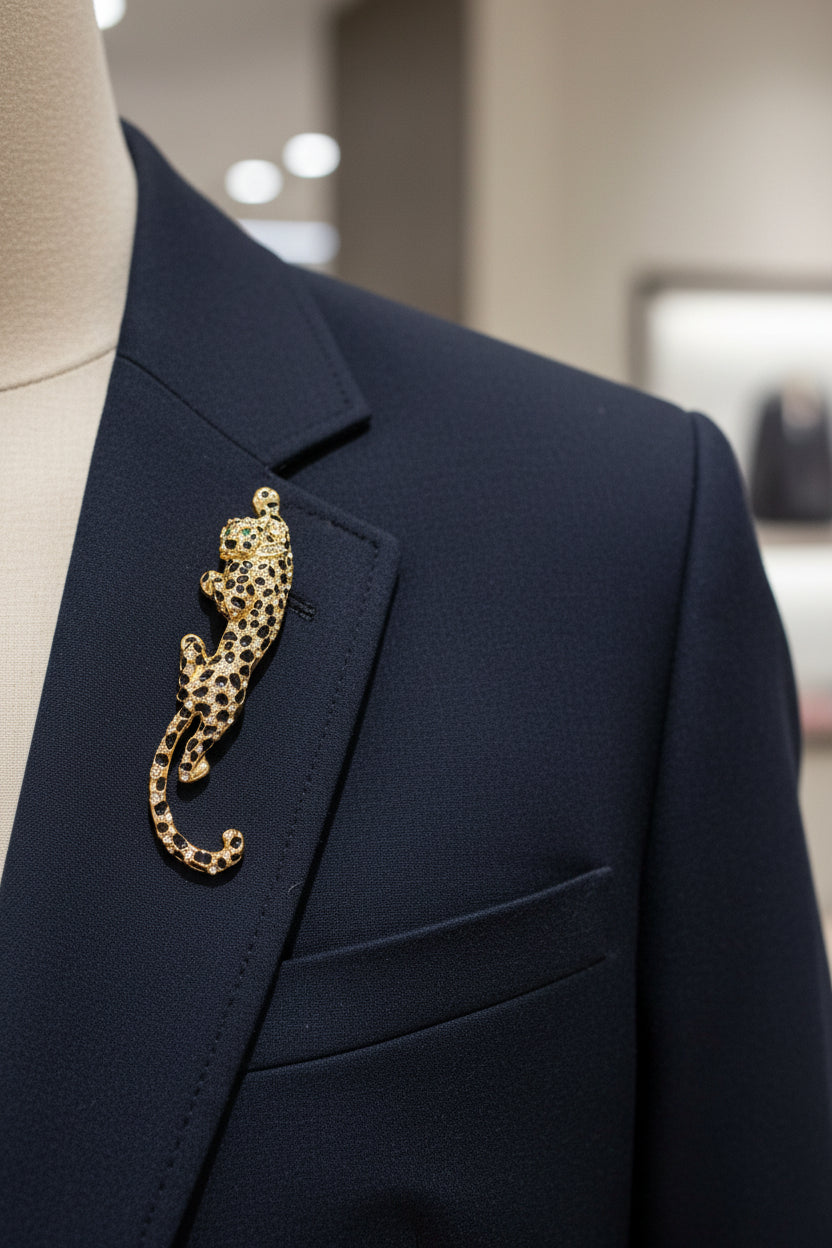 Gold and black jeweled leopard-shaped brooch on a white background