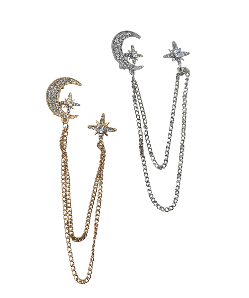 Celestial chain brooches laid flat on a white background. One is gold-toned with a crescent moon and star details set with clear rhinestones, and the other is silver-toned with matching moon and star designs.