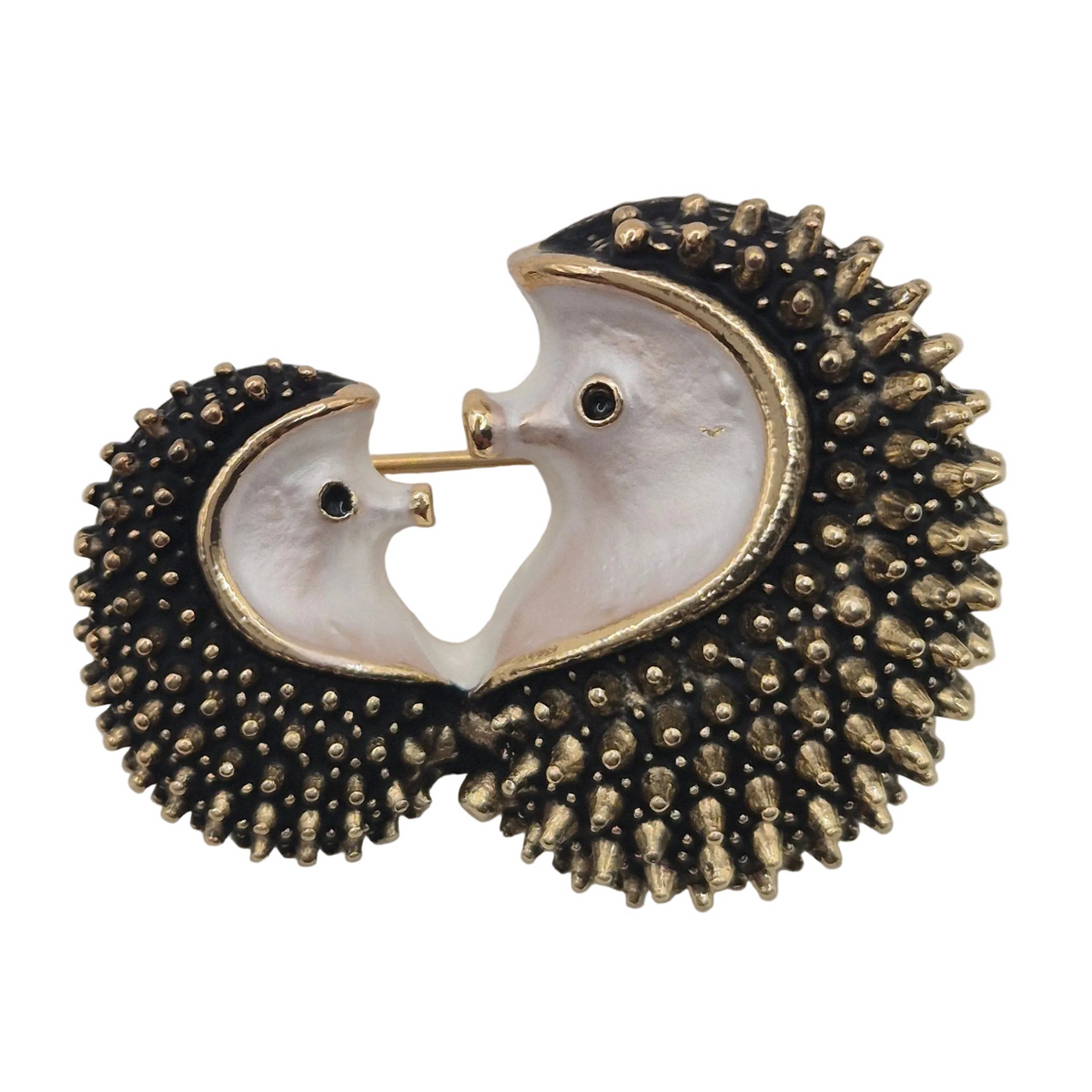 A pair of hedgehogs facing each other with dark textured spines, and gold-tone outlines and eyes, shown on a plain white background.