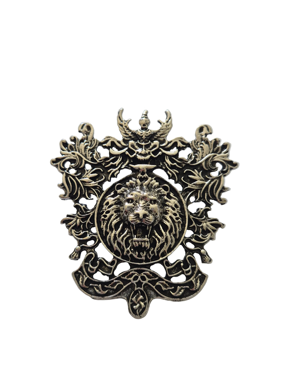silver metal brooch with a lion's head design on a white background