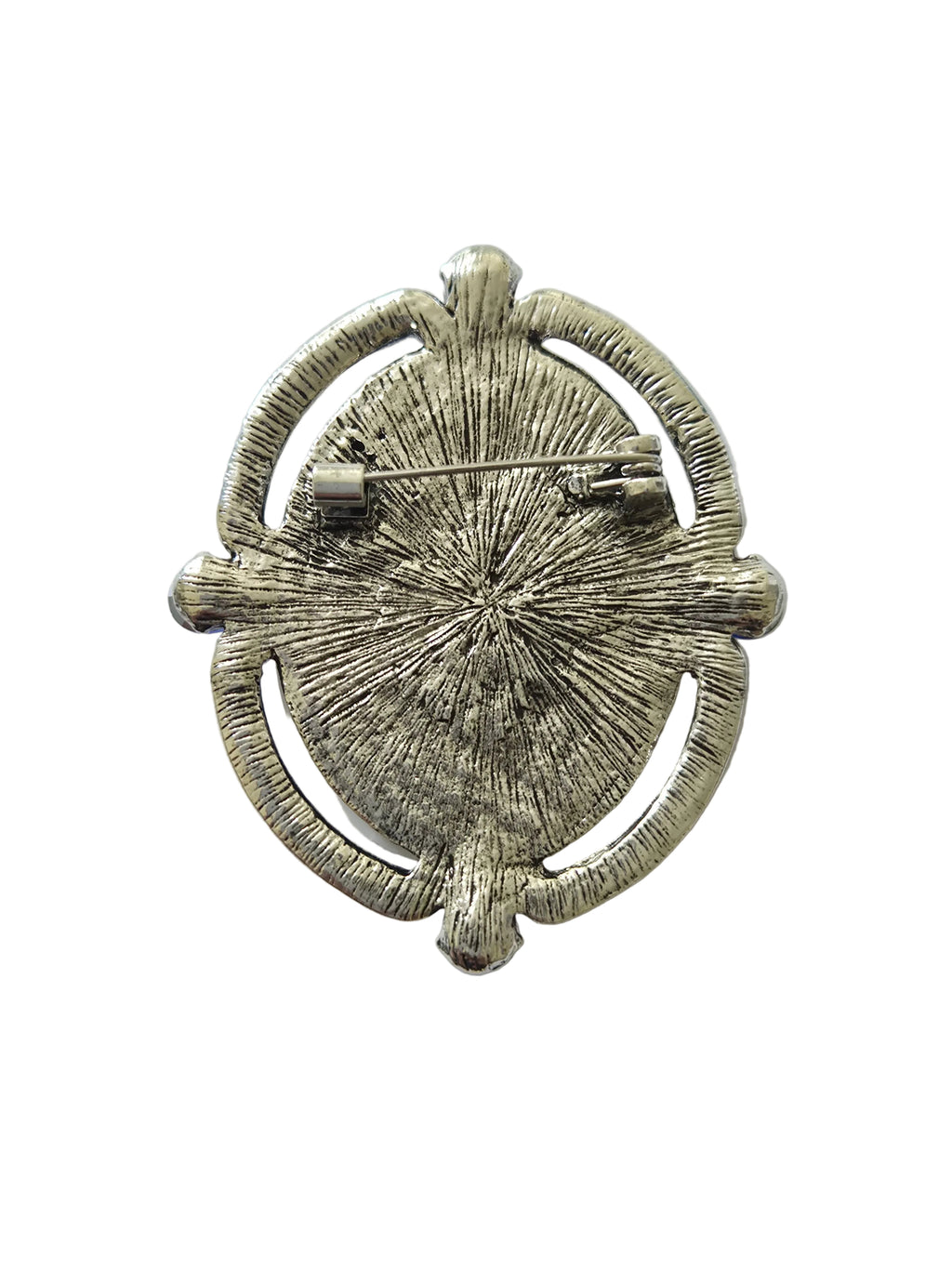 Silver brooch with textured design on a light gray background