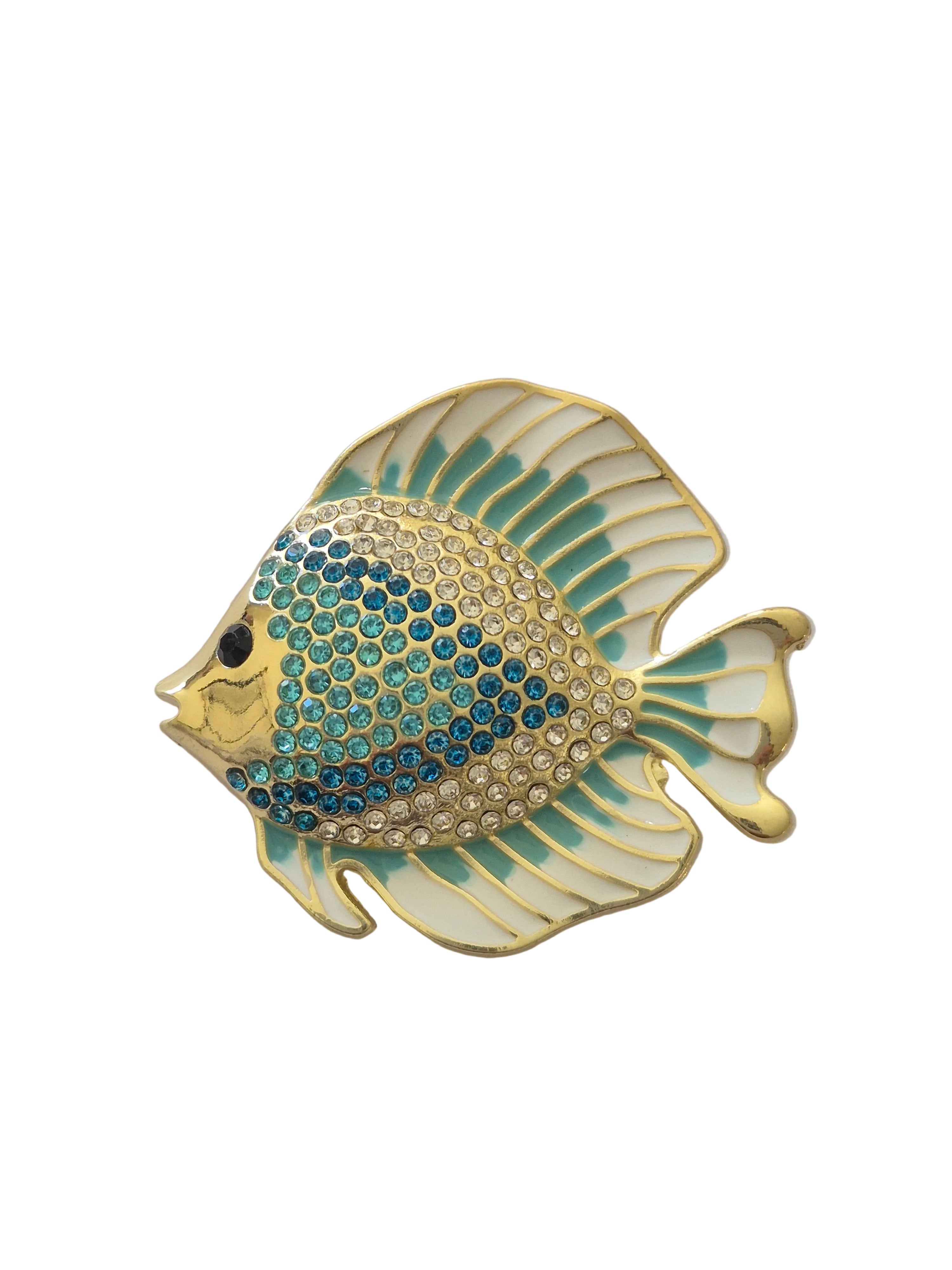 Decorative fish-shaped brooch with gold and blue details on a white background