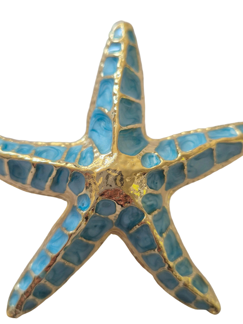 Starfish-shaped brooch with blue and gold mosaic design on a white background