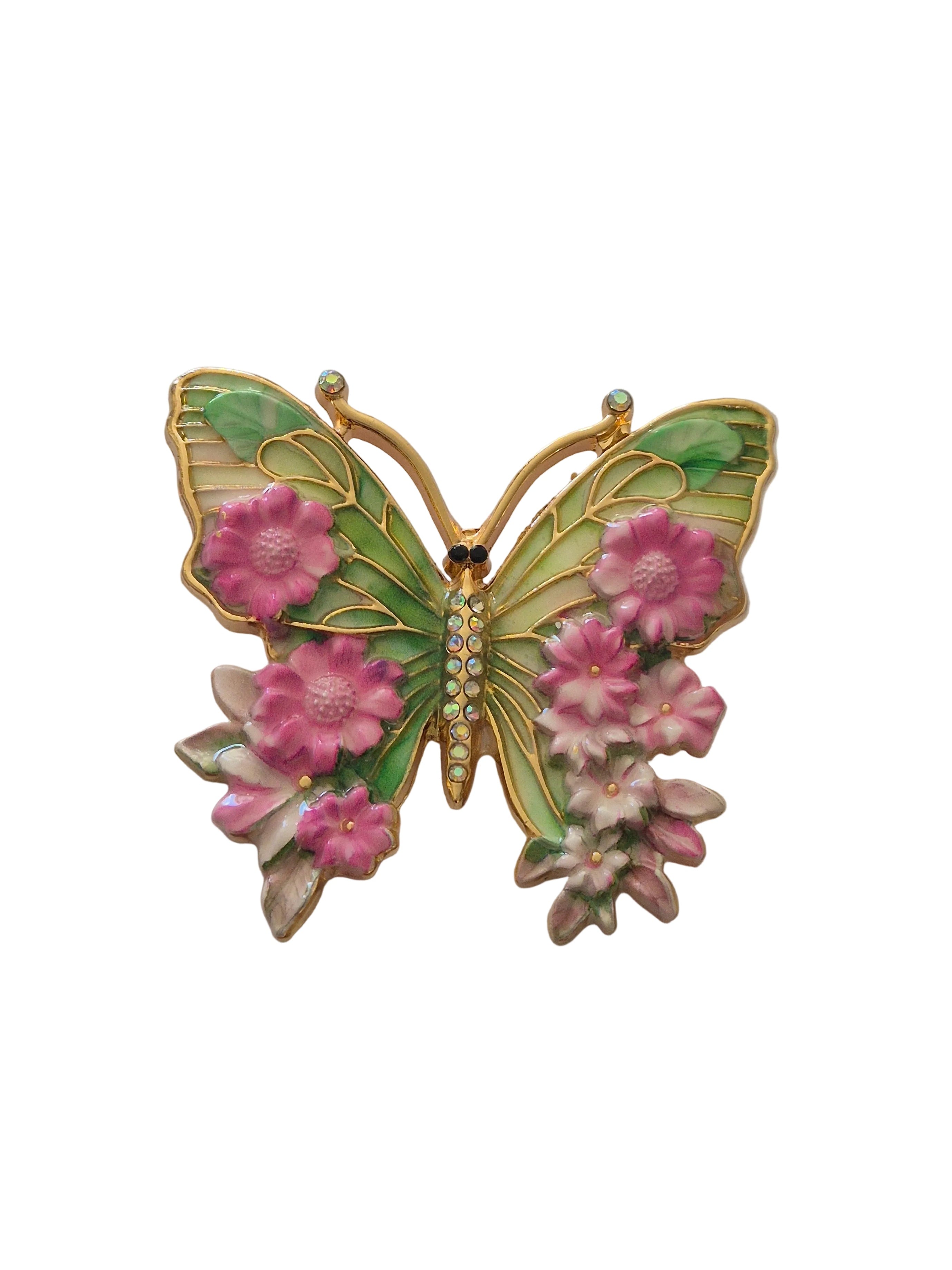 Butterfly-shaped brooch with pink flowers on a white background