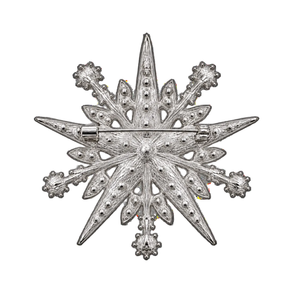 A silver-toned Christmas star brooch with textured detailing and small bead accents, shown flat against a plain white background.