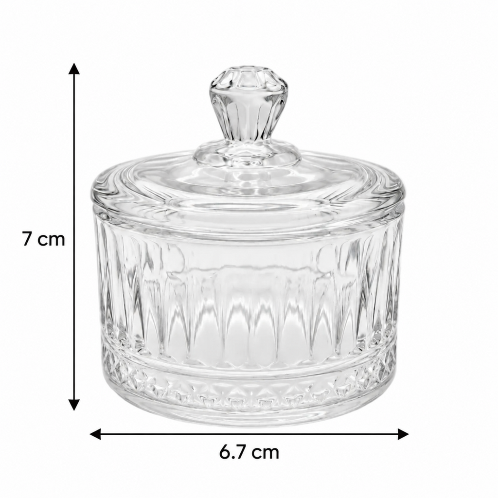 A clear glass lidded container with a faceted knob top and ribbed glass body, shown on a white background with dimension arrows and labels indicating 7 cm height and 6.7 cm width.