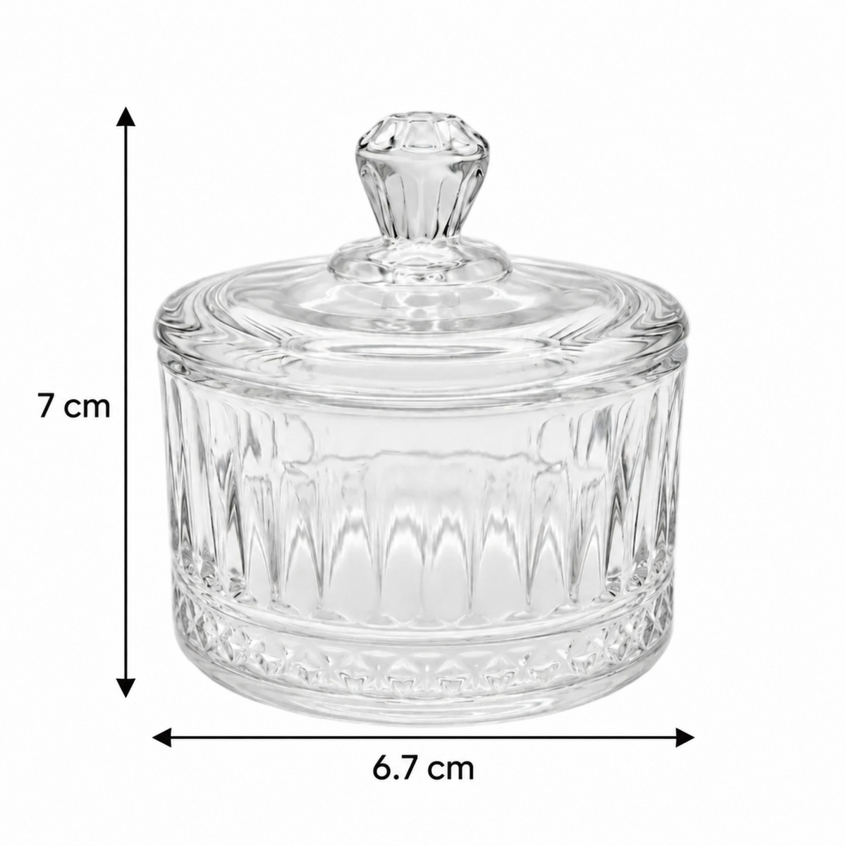 A clear glass lidded container with a faceted knob top and ribbed glass body, shown on a white background with dimension arrows and labels indicating 7 cm height and 6.7 cm width.