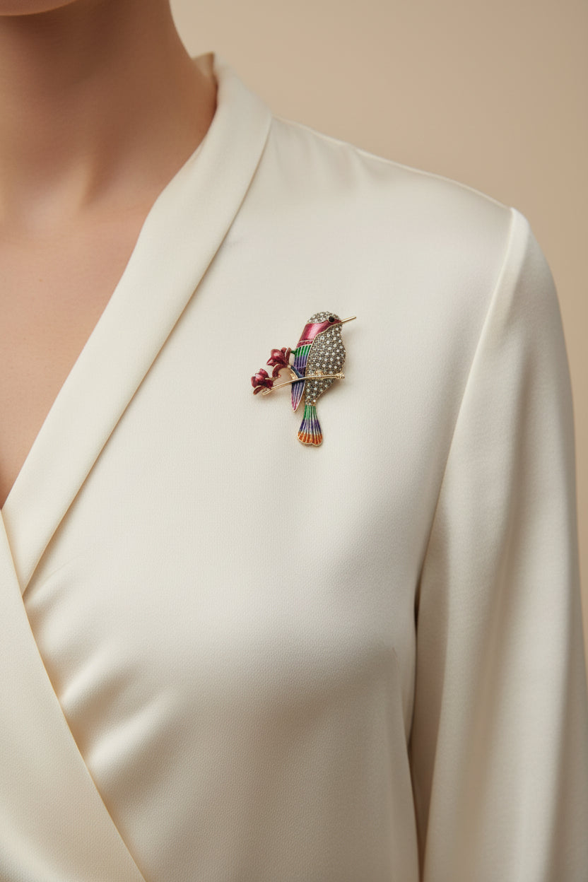 Colorful bird-shaped brooch on a gray background