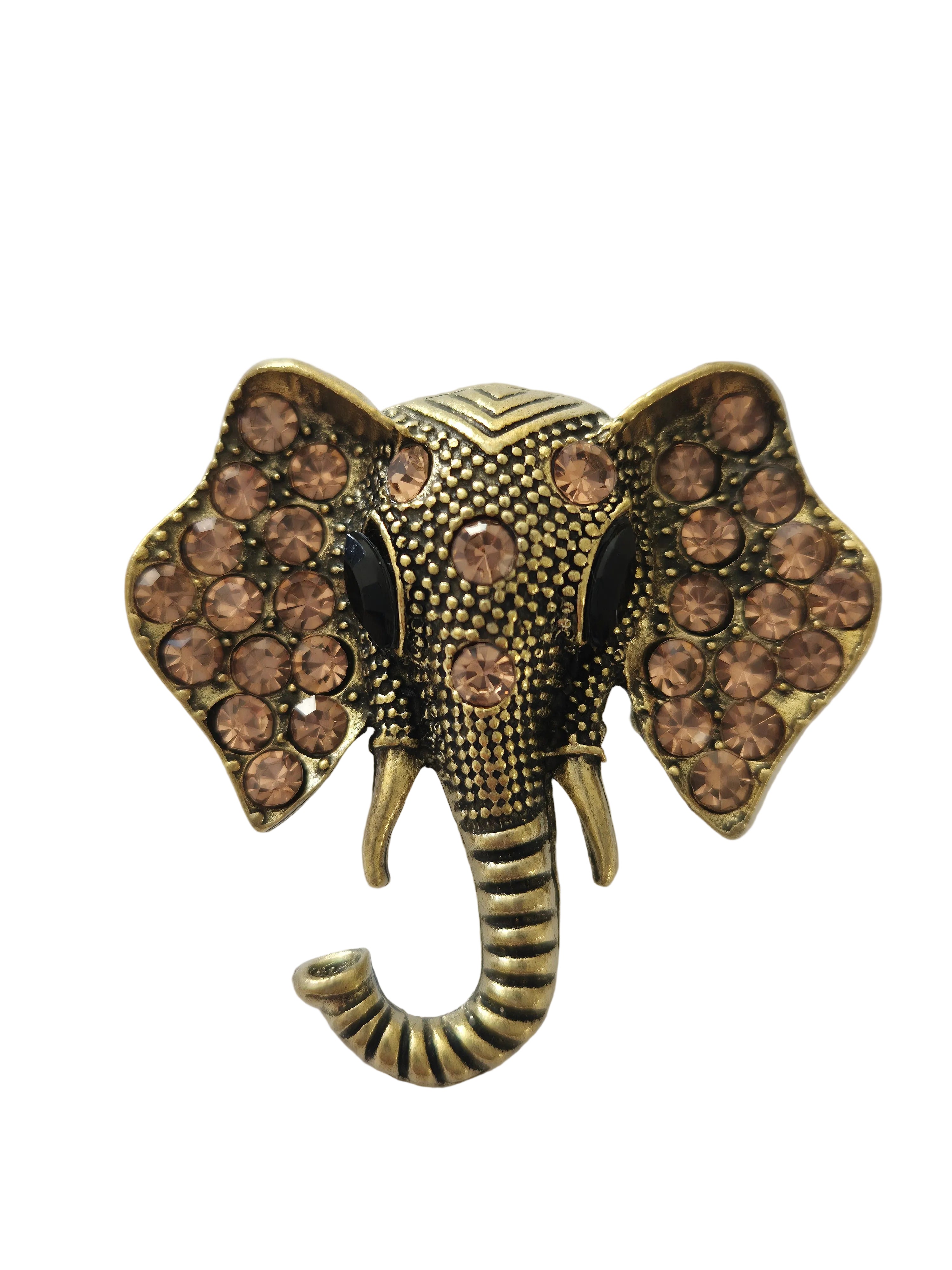 gold silver elephant brooch with brown gemstones on a white background