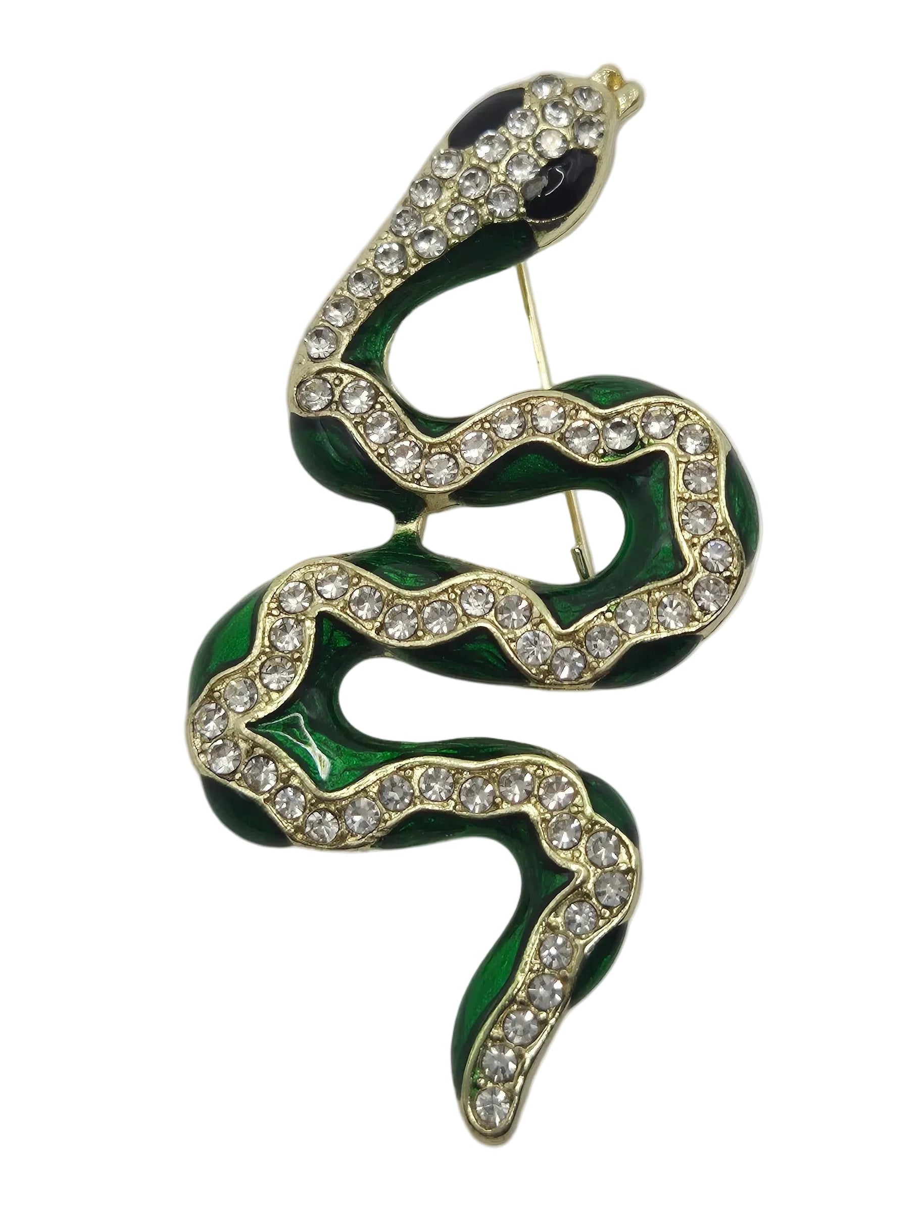 A gold-plated snake-shaped brooch with dark green enamel sections and clear rhinestones along the body, set against a plain white background.