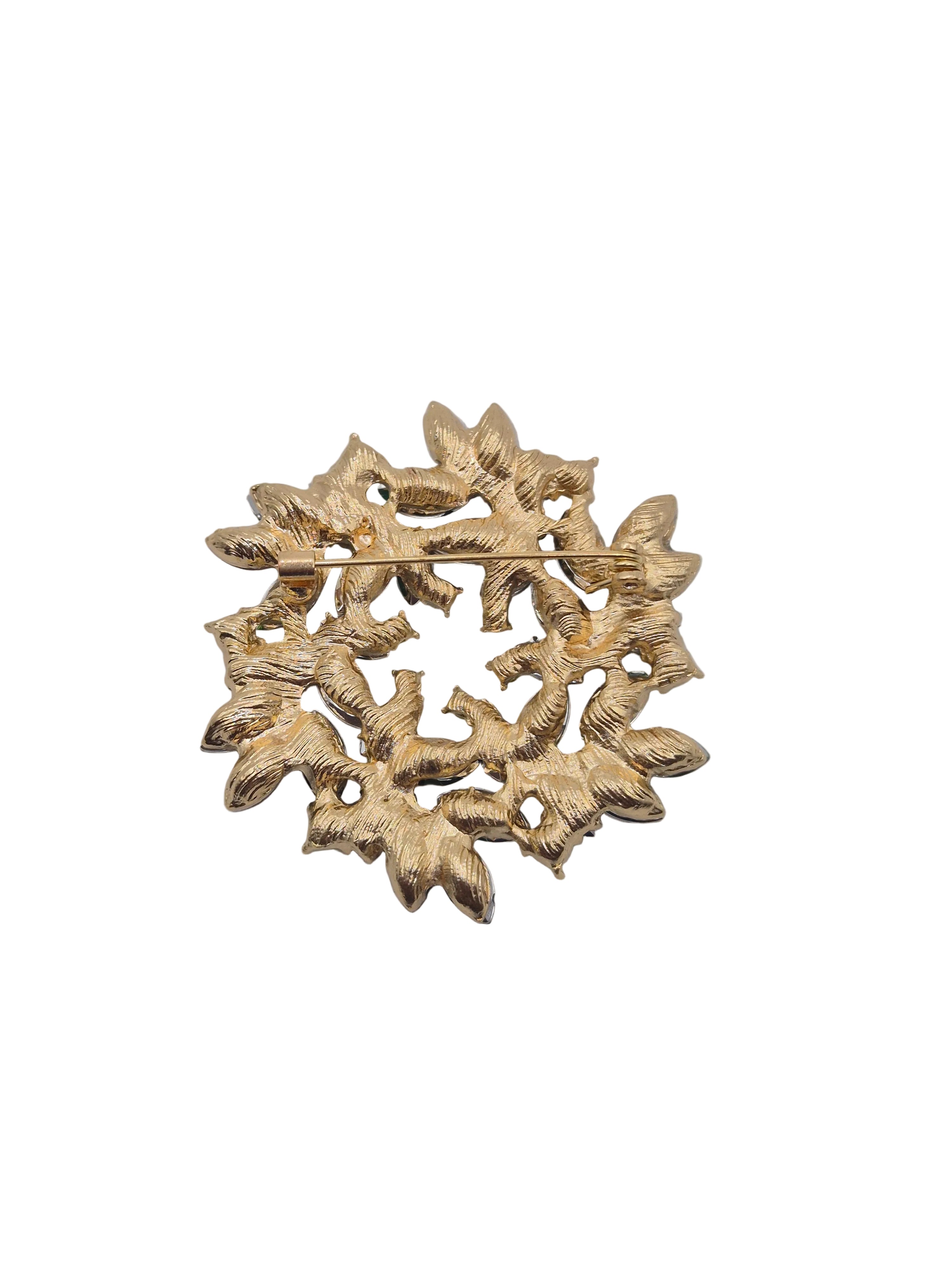 Decorative gold brooch on a gray background