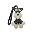 A small dog-shaped leather keychain or bag charm with a black and cream colour scheme, featuring a loop strap at the top, photographed on a white background.